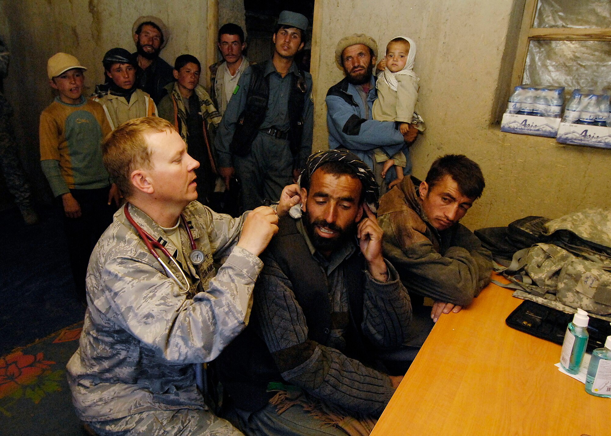 PANJSHIR PROVINCE, Afghanistan - Capt. Glenn Little, Provincial Reconstruction Team chief medical officer, examines an Afghan local during a medical engagement here May 29. Captain Little, who is deployed from the 92nd Medical Operations Squadron, Fairchild Air Force Base, Wash., examined more than 40 patients. (U.S. Air Force photo by Master Sgt. Demetrius Lester)