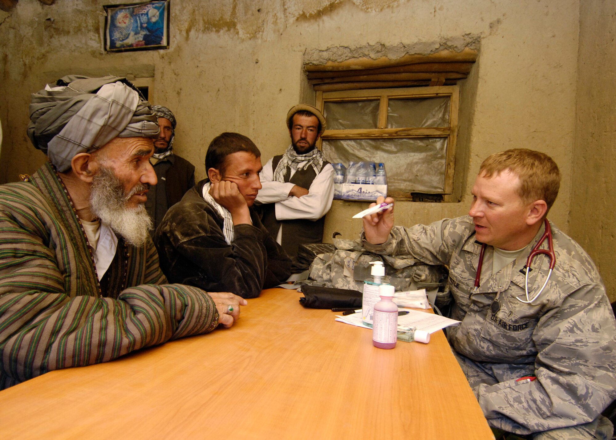 PANJSHIR PROVINCE, Afghanistan - Capt. Glenn Little, Provincial Reconstruction Team chief medical officer, talks to an Afghan local about a prescription during a medical engagement here May 29. Captain Little, who is deployed from the 92nd Medical Operations Squadron, Fairchild Air Force Base, Wash., examined more than 40 patients. The PRT's primary mission is security, governance, reconstruction and developement. (U.S. Air Force photo by Master Sgt. Demetrius Lester)