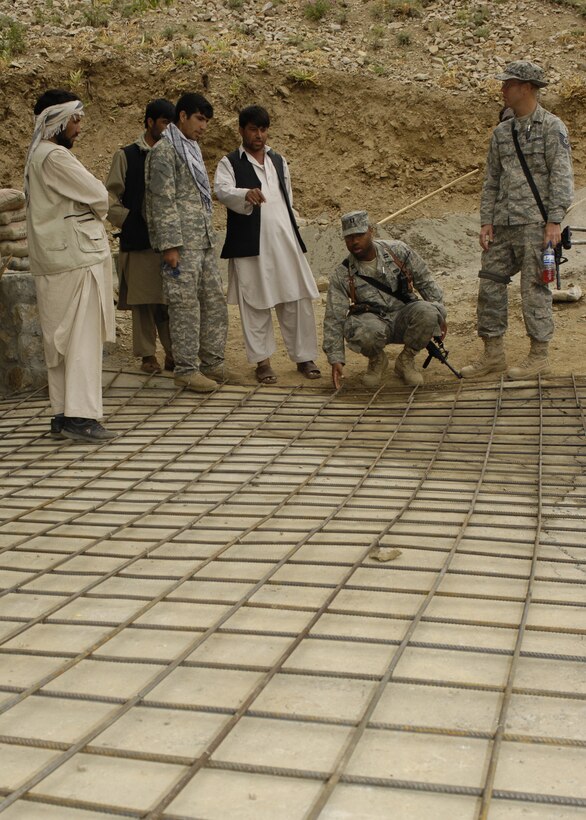 PANJSHIR PROVINCE, Afghanistan - Capt. Kenneth McGinnis (middle) Provicial Reconstruction Team project engineer, and Tech. Sgt. David Saugstad (right) Provincial reconstruction Team structural engineer, quality controls a bridge being built so the locals will have access to a medical clinic here May 28. As of now, the locals walk and climb through the local terrain. The Panjshir PRT's primary mission is to help reconstruct Afghanistan and build U.S./Afghan relations. Capt. McGinnis is deployed from the 28th Civil Engineer Squadron Ellsworth Air Force Base, S.D. and Sergeant Saugstad is deployed from the 1st Special Operations Civil Engineer Squadron, Hurlburt Field, Fla. (U.S. Air Force photo by Master Sgt. Demetrius Lester)
