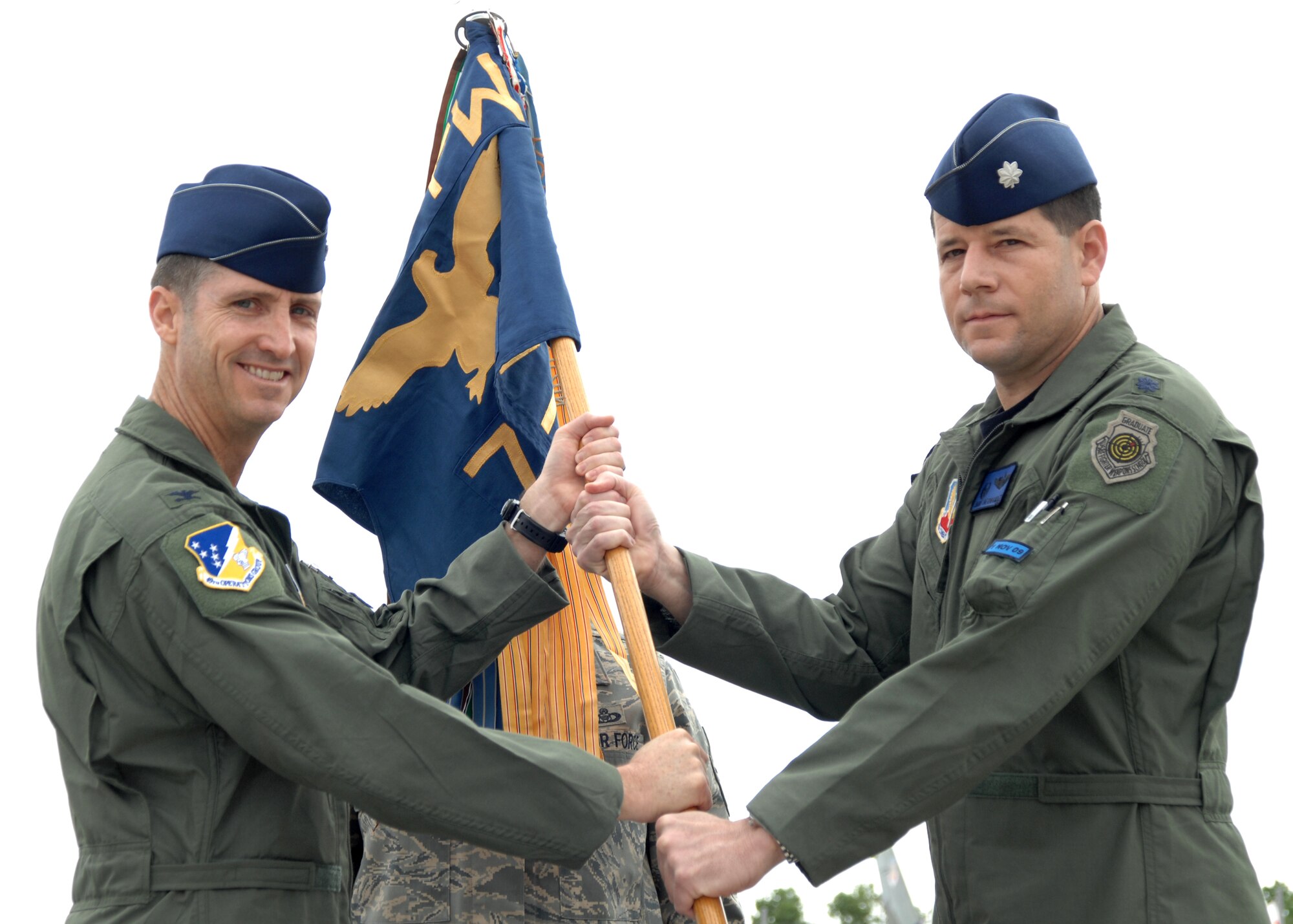 Col. Jack Forsythe, 49th Operations Group commander, hands off the guideon to Lt. Col. Mike Hernandez, incoming 7th Fighter Squadron commander, during the squadron's activation ceremony, May 16 at Holloman Air Force Base, N.M. The 7th FS was reactivated in preparation for the arrival of the F-22A Raptor. (U.S. Air Force photo/Airman 1st Class Jamal Sutter)