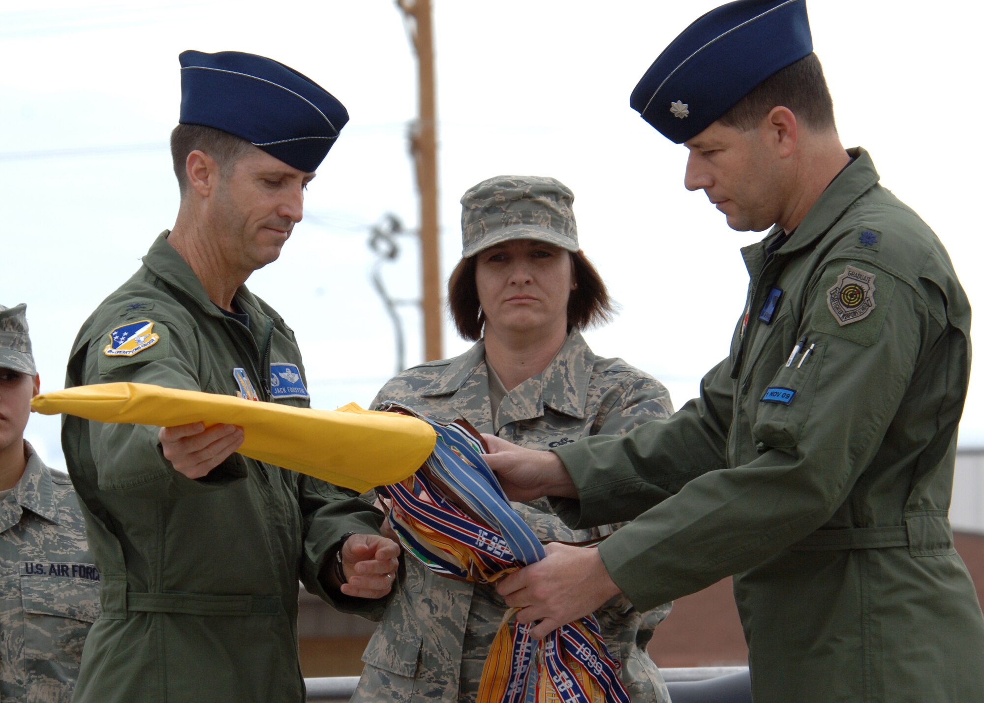 Col. Jack Forsythe, 49th Operations Group commander, and Lt. Col. Mike Hernandez uncase the 7th Fighter Squadron guidon, May 16 at Holloman Air Force Base, N.M. Colonel Hernandez assumed command of the of the 7th FS. (U.S. Air Force photo/Airman 1st Class John Strong)
