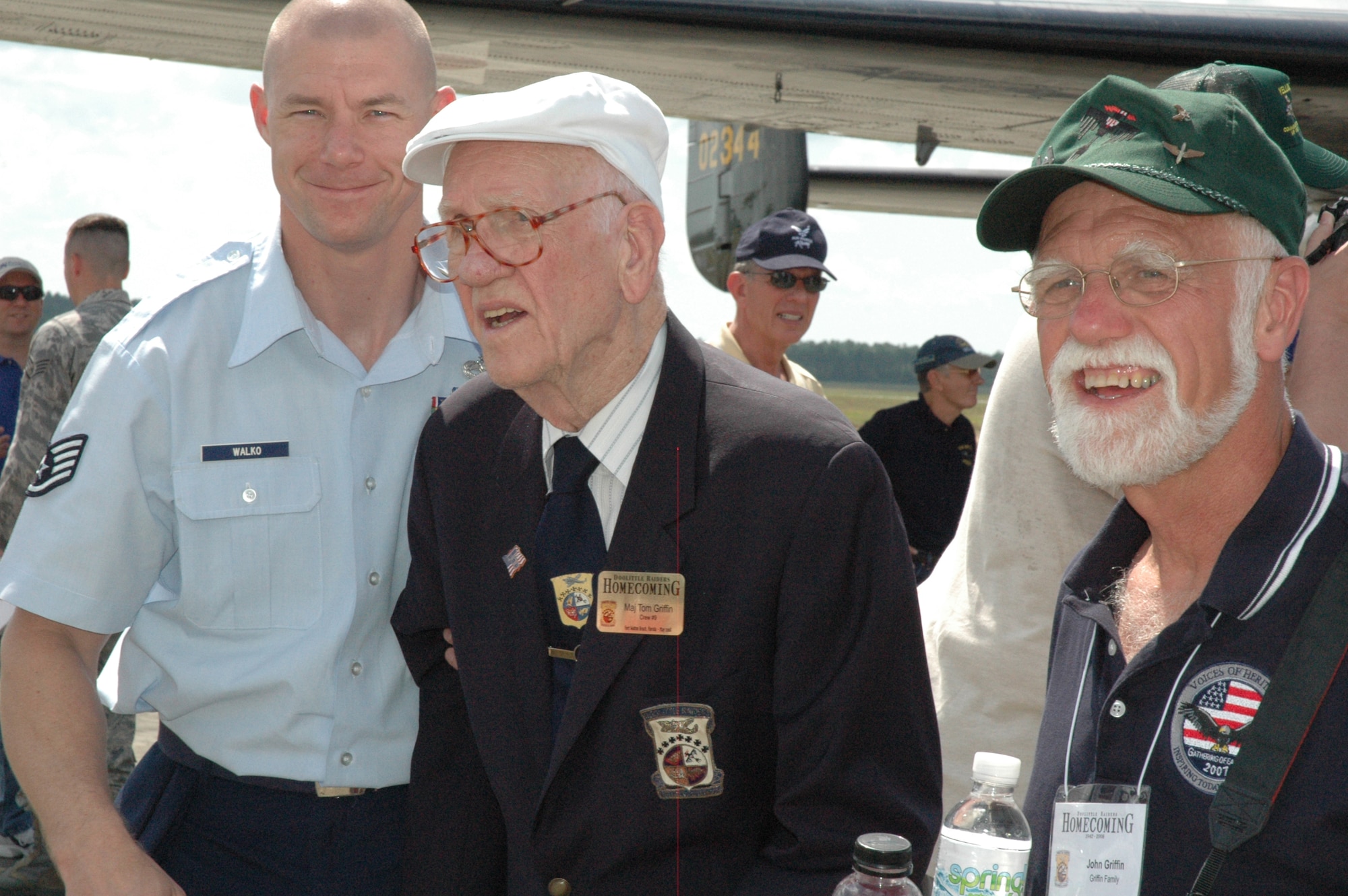 EGLIN AIR FORCE BASE, Fla. -- Staff Sgt. Sean Walko, 96th Communications Squadron, volunteered to escort Doolittle Raider retired Maj. Tom Griffen during the homecoming ceremony at Duke Field May 31. Major Griffen shared the event with his son, John. (U.S. Air Force photo/Staff Sgt. Stacia Zachary)