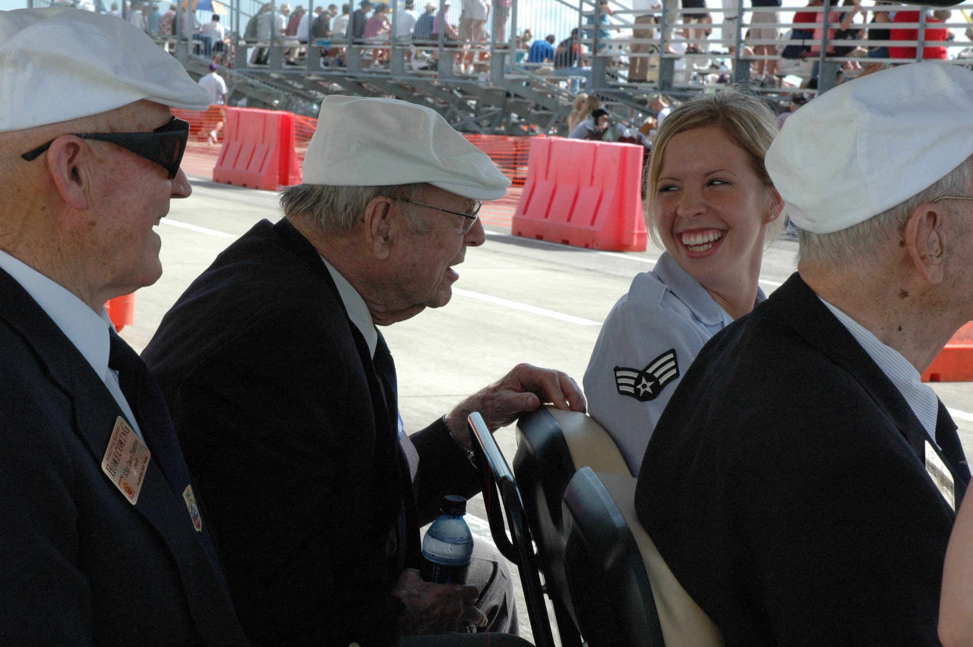 EGLIN AIR FORCE BASE, Fla. -- Senior Airman Robin Parks, 96th Logistics Readiness Squadron, shares a joke with the Doolittle Raiders while escorting them to the tarmac where three B-25 Mitchells were on static display during the Doolittle Raiders Homecoming event May 31 at Duke Field. (U.S. Air Force photo/Staff Sgt. Stacia Zachary)