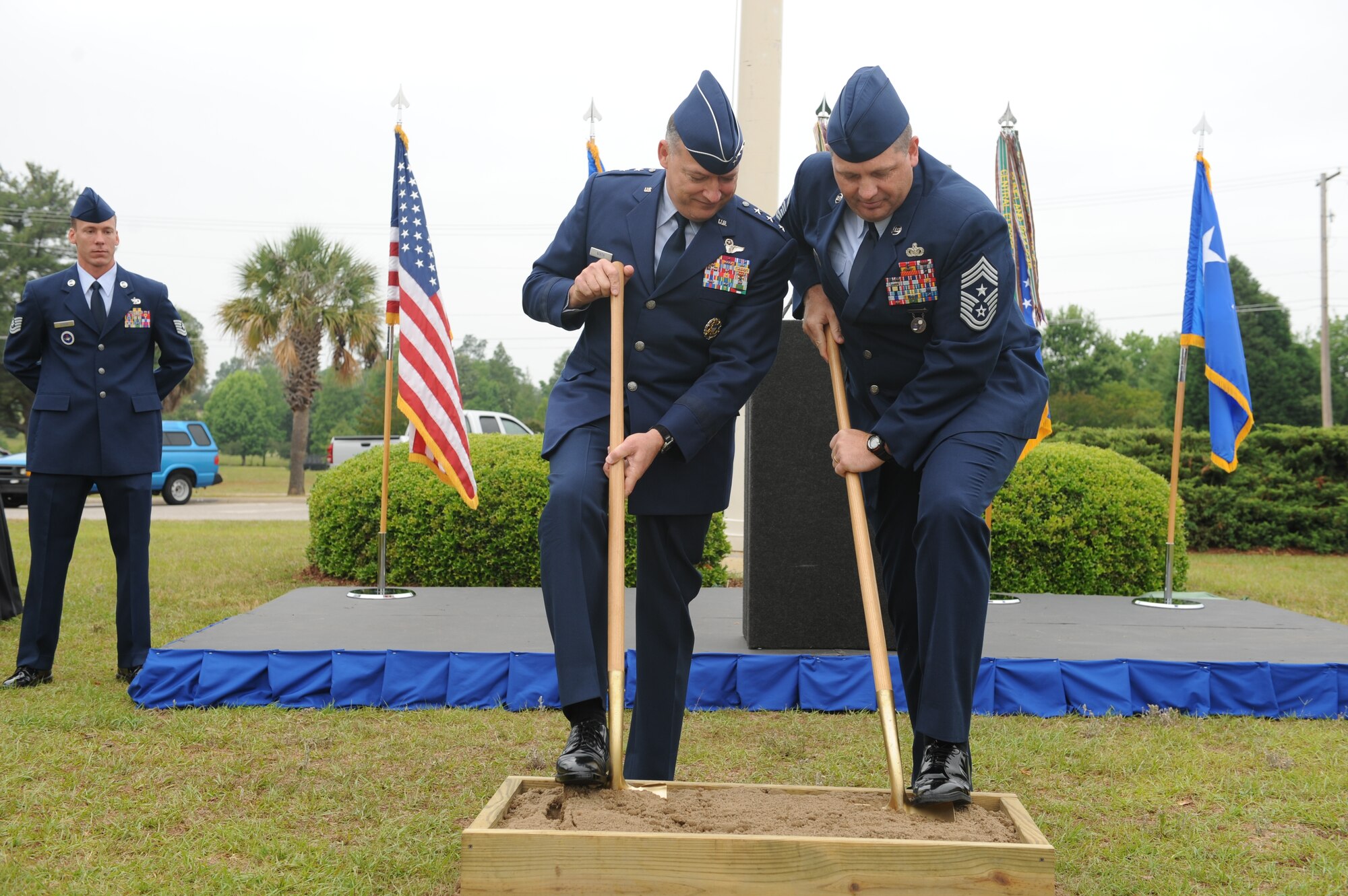 SHAW AIR FORCE BASE, S.C.— Lt. Gen. Gary North, 9th Air Force and U.S. Air Forces Central commander, and Chief Master Sgt. Scott Dearduff 9th AF and U.S. AFCENT command chief, make the symbolic first dig of the ground breaking  for 9th AF and U.S. AFCENT Airman’s Memorial May 30. The memorial will honor those military members who have fallen or have served or are currently serving since the inception of 9th AF, June 28, 1942. (U.S. Air Force Photo/Staff Sgt. Henry Hoegen) 