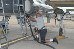 Ross Tonsal, a civilian working with the 12th Flying Training Wing Maintenance Division, refuels a T-38 Talon aircraft Tuesday along the east flightline. (U.S. Air Force photo by Rich McFadden)
