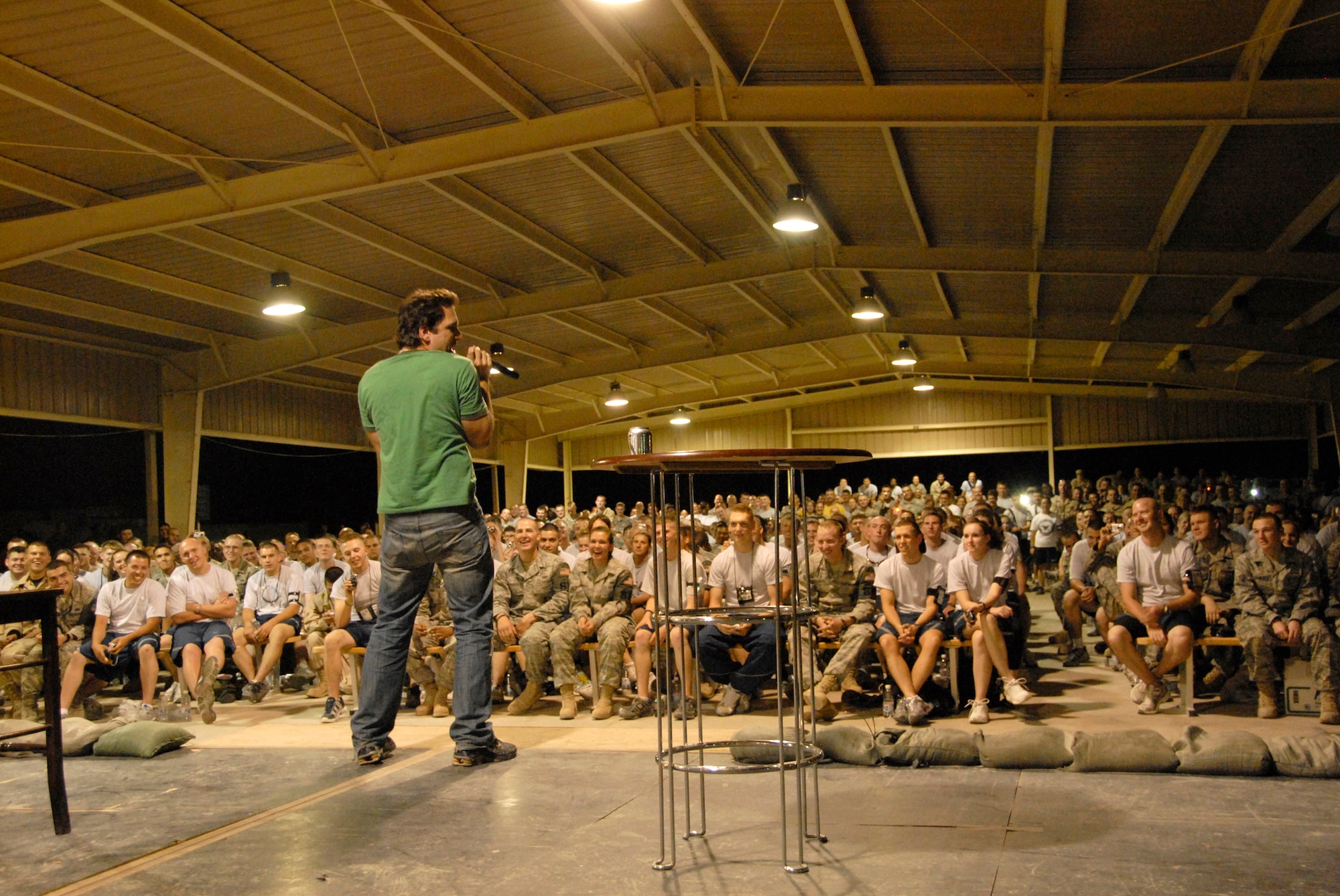 SOUTHWEST ASIA -- Comedian Dane Cook entertains Airmen deployed to the 386th Air Expeditionary Wing during a comedy show May 30, 2008, at an air base in the Persian Gulf Region. Comedians Al Del Bene, Robert Kelly, and Dane Cook are visiting deployed troops throughout the area of responsibility during a five-day United Service Organizations sponsored Combat Comedy Tour. (U.S. Air Force photo/ Staff Sgt. Patrick Dixon)