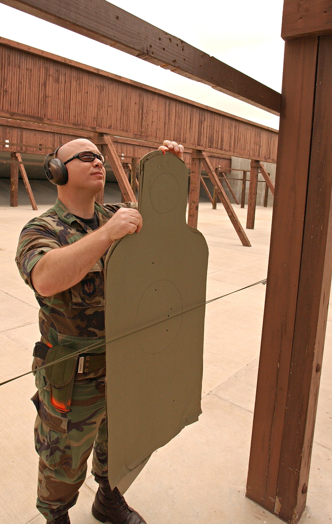 Capt. Kurt Huntzinger, 39th Operations Squadron, hangs his target during his M-9 qualification May 16. Captain Huntzinger was part of the first class to fire at the Combat Arms Training and Maintenance range since it reopened. (U.S. Air Force photo by Airman 1st Class Benjamin WIlson)