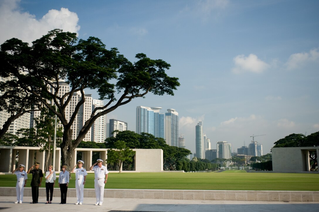 Hubert Caloud, assistant superintendent of the Manila American Cemetery and Memorial; Ricardo Morales, commander of the Philippine Army's Headquarters and Headquarters Support Group; U.S. Ambassador to the Philippines, Kristie Kenney; Mrs. Deborah Mullen; Adm. Mike Mullen, chairman of the Joint Chiefs of Staff, and cemetery Superintendent Larry A. Adkison salute during the playing of Taps in honor of the 17,202 servicemembers killed in operations in New Guinea and the Philippines during World War II buried at the Manila American Cemetery and Memorial, Republic of the Philippines, June 2, 2008.  Defense Dept. photo by Chief Petty Officer 1st Class Chad J. McNeeley