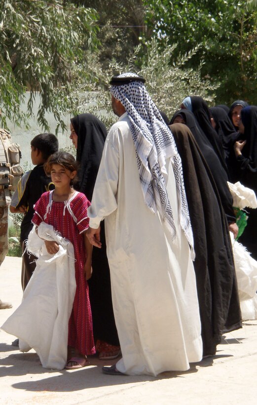 A girl waits with her family as Iraqi and U.S. soldiers distribute food and toys during a humanitarian assistance operation in Dehna, a village west of Baghdad, May 29, 2008. U.S. Army photo by Spc. Dustin Weidman
