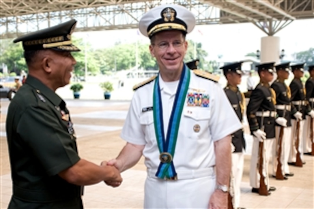 U.S. Navy Adm. Mike Mullen, chairman of the Joint Chiefs of Staff, is welcomed by Lt. Gen Alexander M. Yano, chief of staff, Armed Forces of the Philippines, to General Headquarters, Armed Forces of the Philippines, Manila, Republic of the Philippines, June 2, 2008.  Mullen is on an eight-day tour visiting Asian Pacific nations, their leaders and troops assigned to the region.  