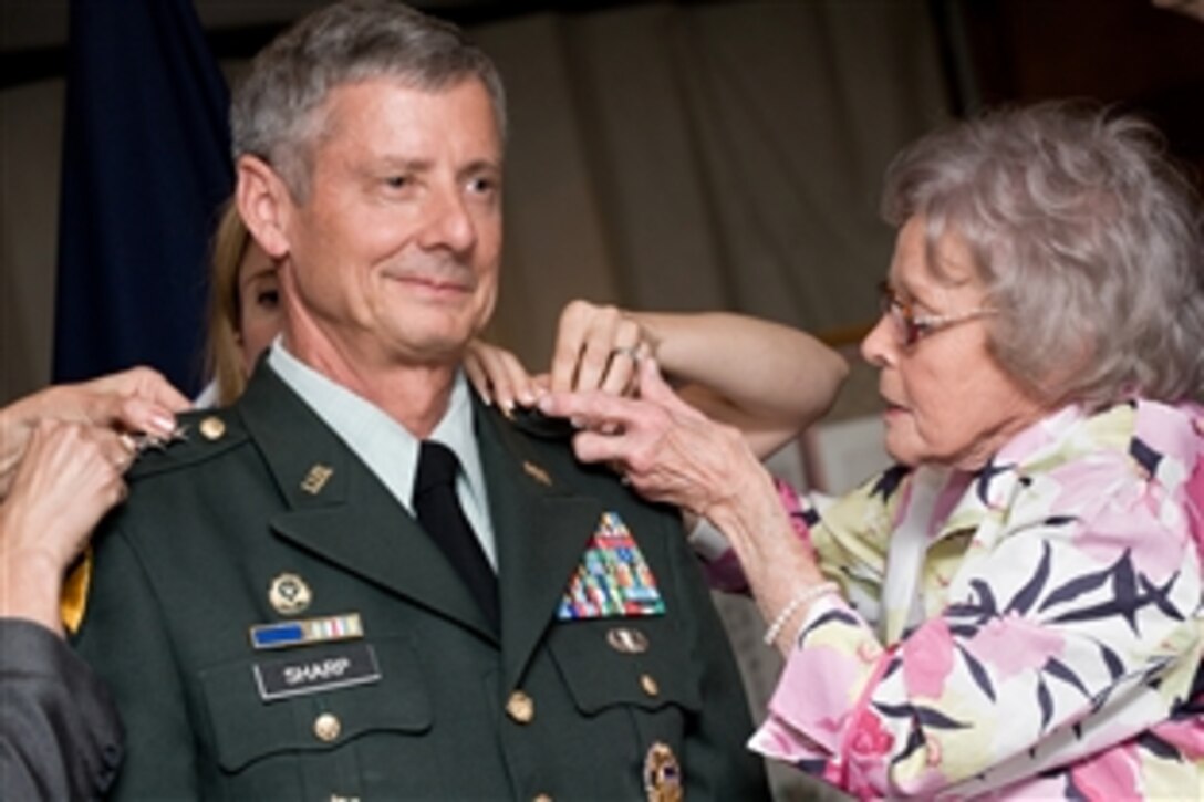 U.S. Army Gen. Walter Sharp is aided by his family in pinning on his new four-star rank during a promotion ceremony presided over by U.S. Navy Adm. Mike Mullen, chairman of the Joint Chiefs of Staff, Yongsan Army Garrison, South Korea, June 2, 2008. Sharp will take command of U.S. Forces Korea. 