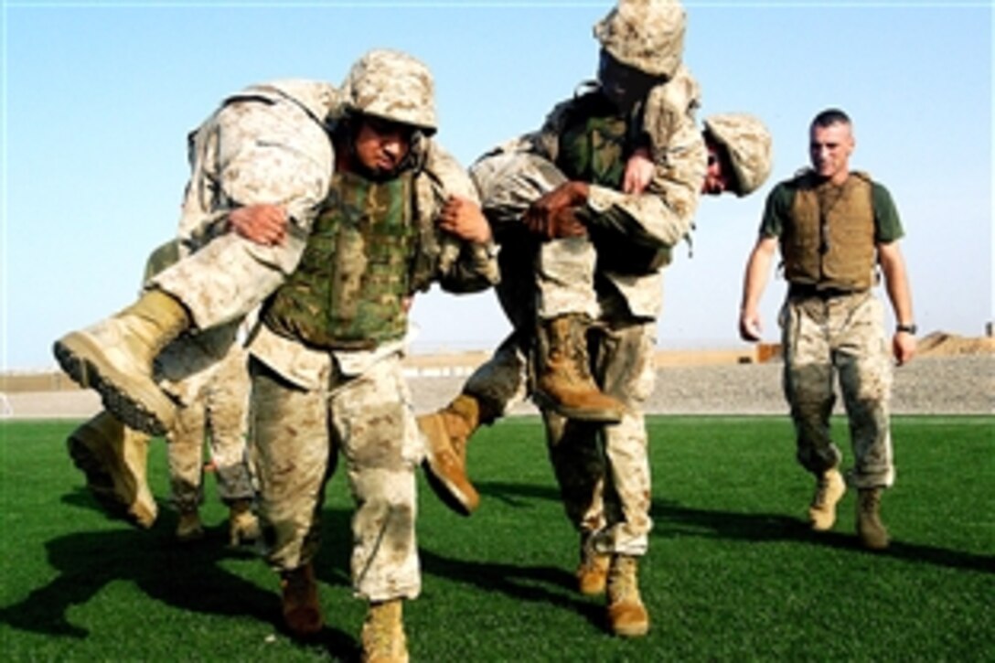 U.S. Marine Staff Sgt. Jason Gray, right, a Marine Corps martial arts instructor, watches his team perform drills at Camp Lemonier, Djibouti, May 30, 2008. The Marine Corps Martial Arts Program combines hand-to-hand and close quarters combat techniques with morale and team-building instruction. 