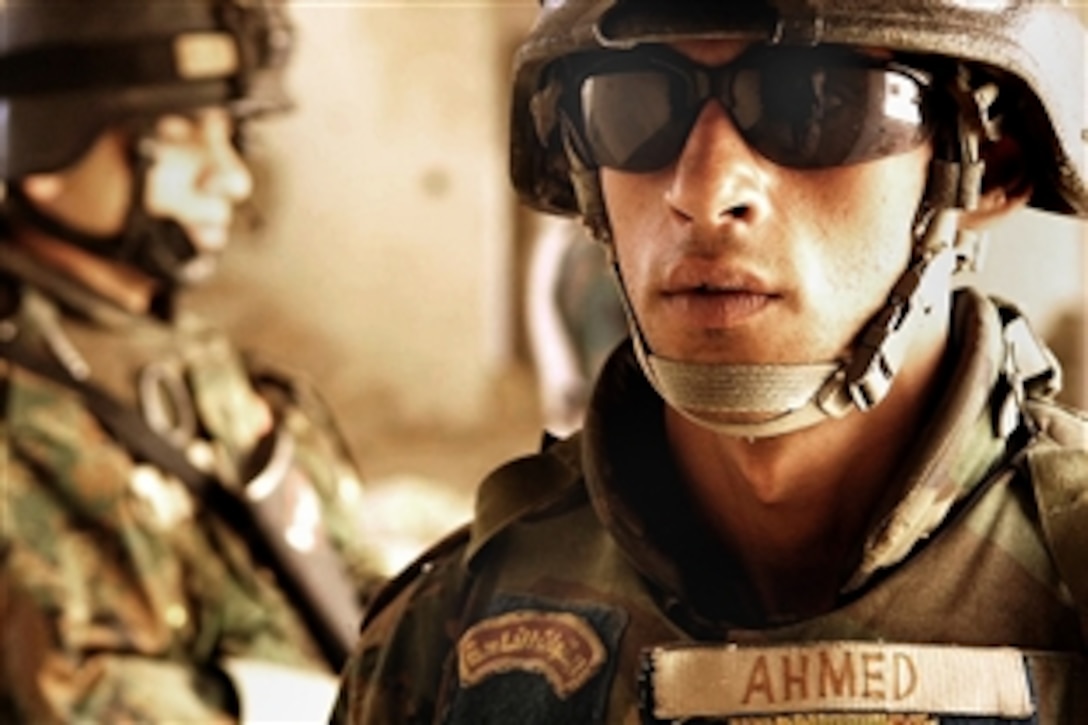 Iraqi soldiers pull security during a site survey of a building in Ghazaliya, Iraq, on May 29, 2008. They were conducting a humanitarian relief effort to distrIbute food to more than five hundred families. 
