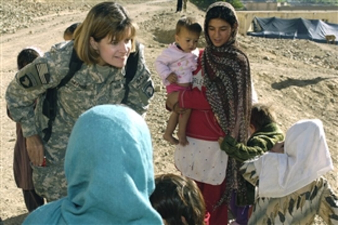 U.S. Army Lt. Col. Betsy Myhre, a nurse practitioner assigned to the Cooperative Medical Assistance Team on Bagram Air Field, looks at children from a nomadic Kuchi tribe before a medical engagement in Dah Khawak, Panjshir, Afghanistan, May 29, 2008. The medical engagements are an opportunity for local Afghan medical providers to partner with coalition providers and build capacity within the Ministry of Public Health.  