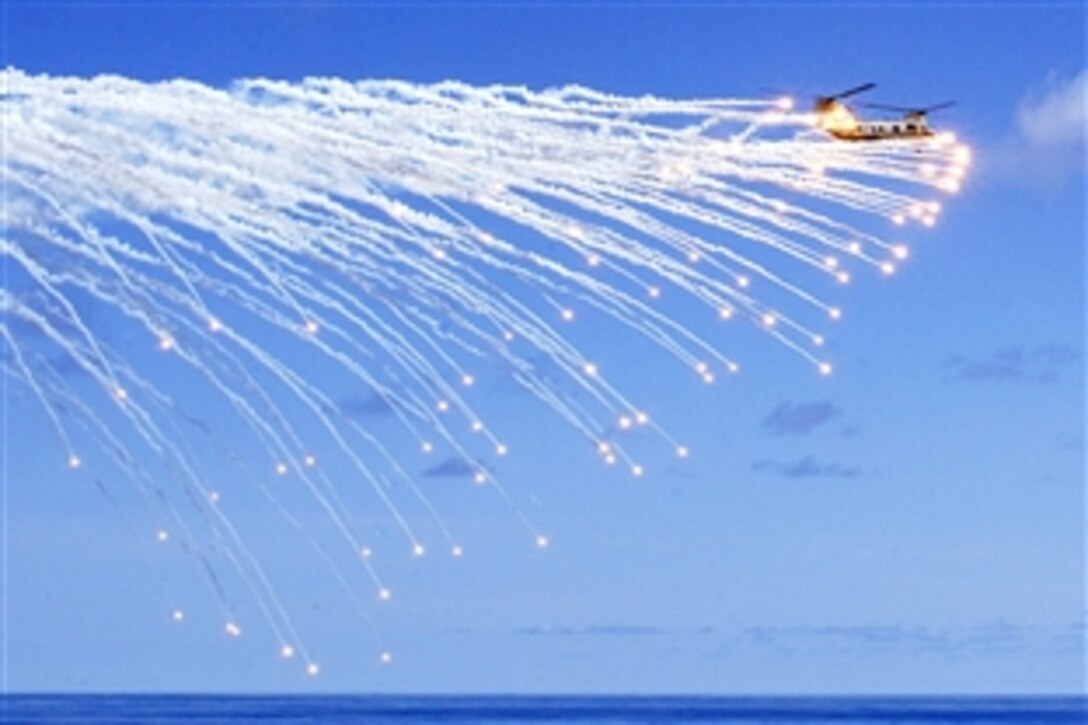 A CH-46 Sea Knight helicopter releases a series of flares during a Marine Air-Ground Task Force demonstration aboard the amphibious assault ship USS Tarawa during the last leg of deployment from Pearl Harbor, Hawaii, to San Diego, Calif., Pacific Ocean, May 30, 2008. 
