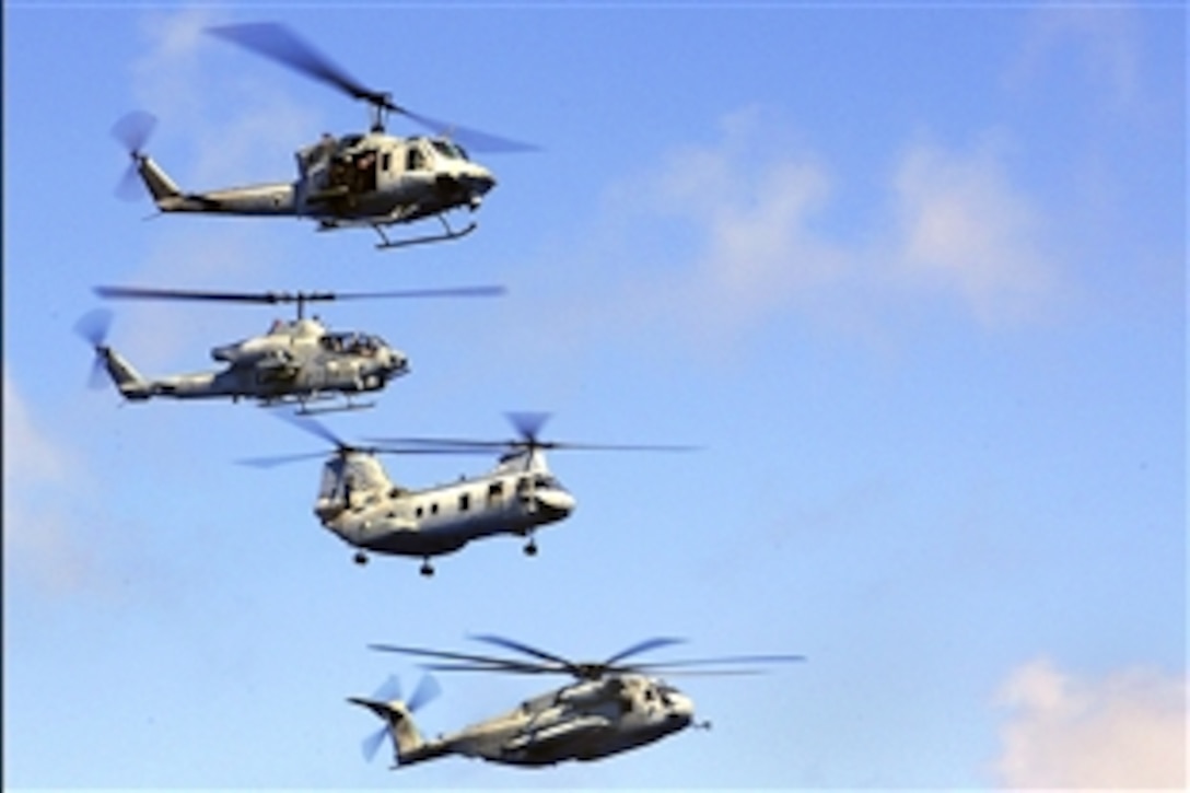 A UH-1N Huey, top, an AH-1W Super Cobra, a CH-46 Sea Knight and a CH-53E Super Stallion fly in formation during a Marine Air-Ground Task Force demonstration aboard the amphibious assault ship USS Tarawa during the last leg of deployment from Pearl Harbor, Hawaii, to San Diego, Calif., Pacific Ocean, May 30, 2008. 