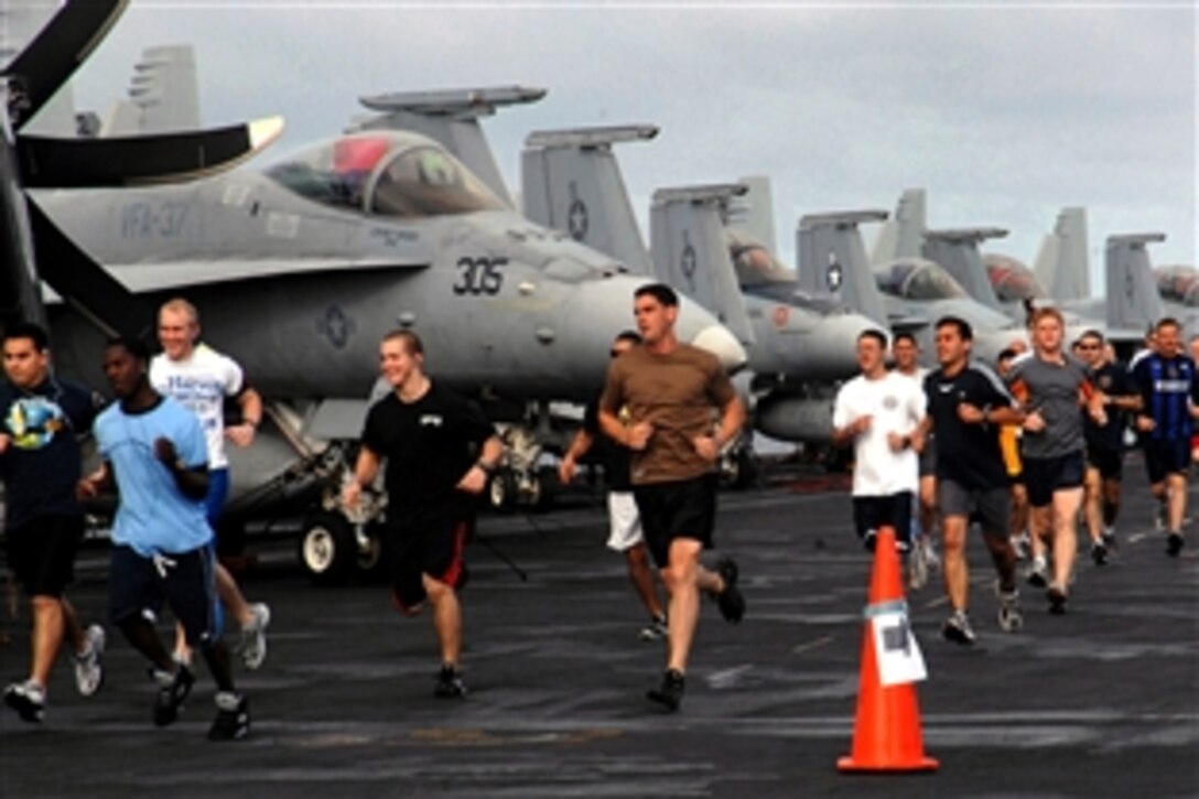 U.S. Navy sailors aboard the USS Harry S. Truman participate in a morning 5k run on the ship's fight deck, Atlantic Ocean, May 28, 2008. 