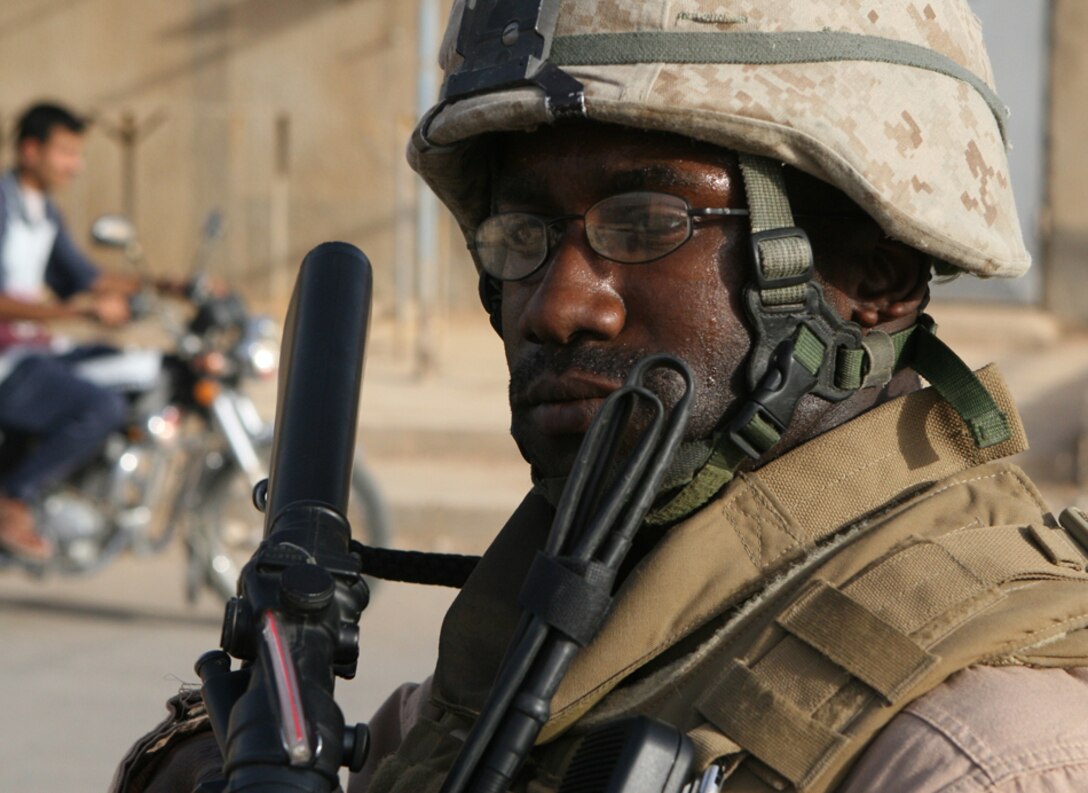 Sgt. Louis Pearson, a communication technician with the Jump Platoon, Task Force 2nd Battalion, 2nd Marines, Regimental Combat Team 5, provides security during an escort mission in Husaybah, Iraq, June 2. They escorted the battalion commander, Lt. Col. Steven J. Grass, during a walk through the streets of Husaybah with the mayor of Al Qa'im, Farhan Tekan Farhan.