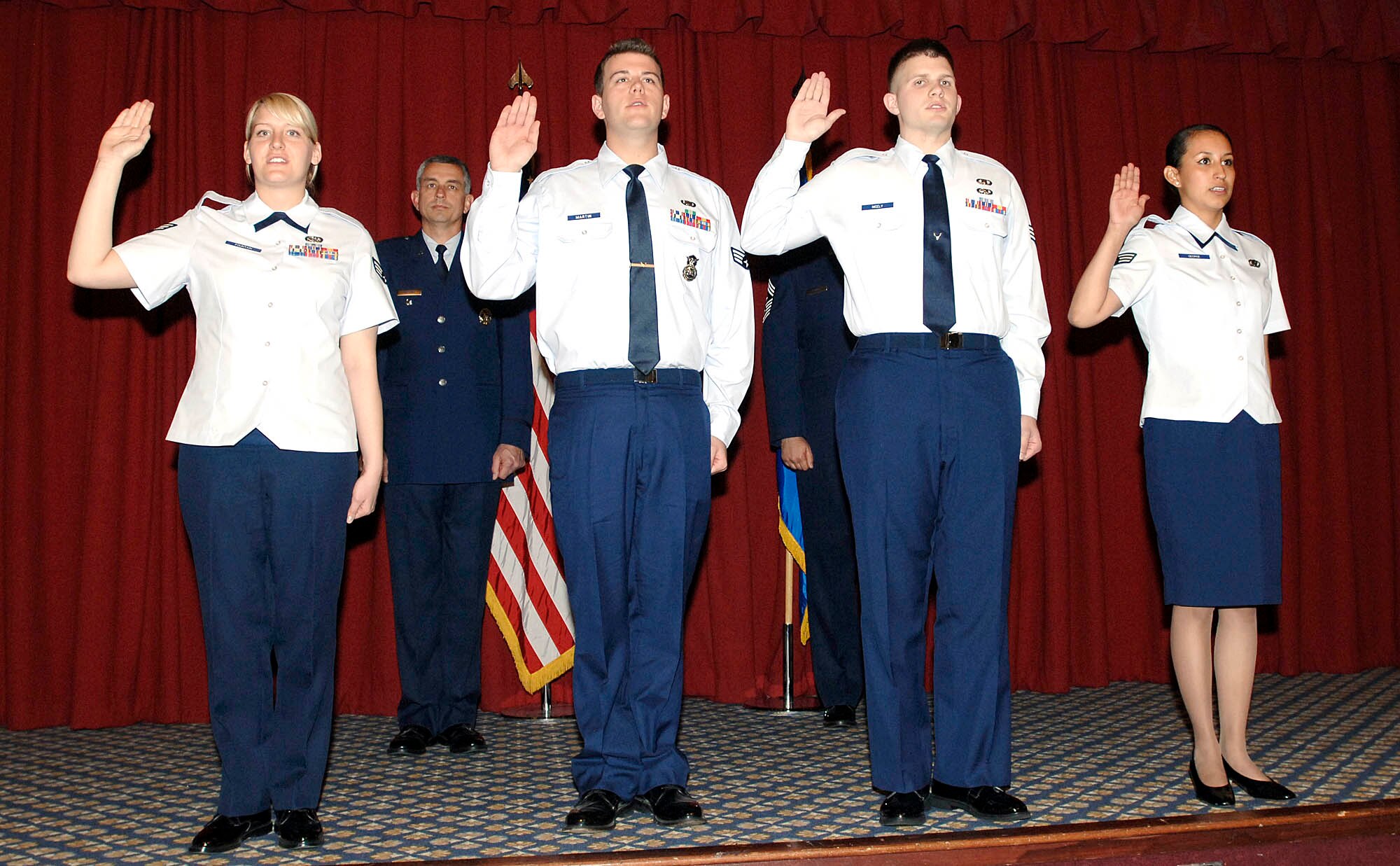 FAIRCHILD AIR FORCE BASE, Wash. – Senior Airman Jessica Fountain, 92nd Services Squadron; Airman James Martin, 92nd Security Forces Squadron; Airman Andrew Nicely, 92nd Operations Support Squadron; and Airman Sandra George, 92nd Comptroller Squadron, recite the Non-Commissioned Officer charge. This event was held at Club Fairchild May 30. (U.S. Air Force photo / Staff Sergeant JT May III)