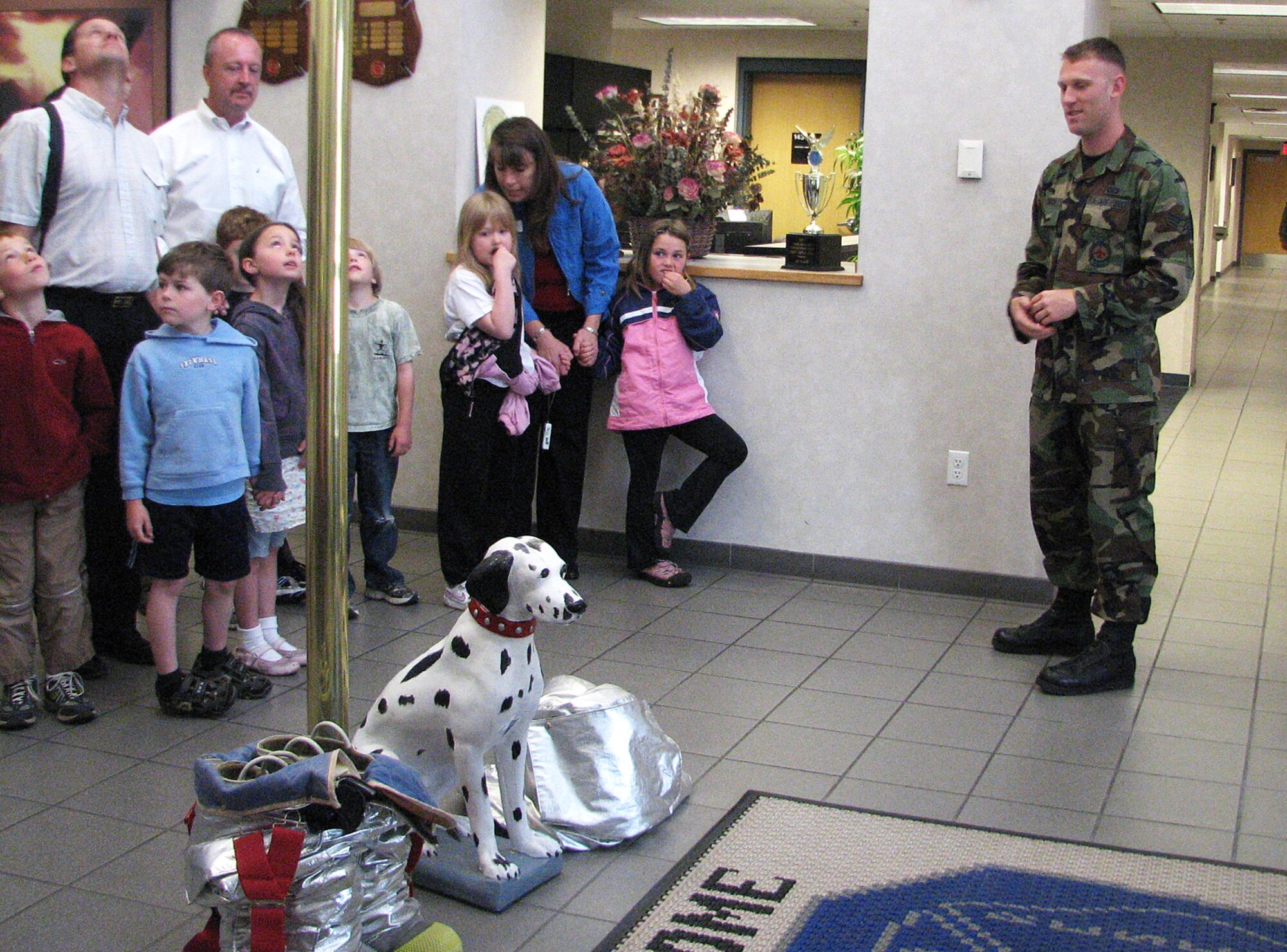 FAIRCHILD AIR FORCE BASE, Wash. – Senior Airman Christopher Solomon, 92nd Civil Engineer Squadron firefighter, leads a group of 12 students and seven chaperones through a tour of Fire Station 1 May 29. The students are from North Wall Elementary School in Spokane, Wash. They also toured a 336th Training Squadron helicopter and the 92nd Operations Support Squadron life support section. (U.S. Air Force photo / Staff Sgt. Connie L. Bias)