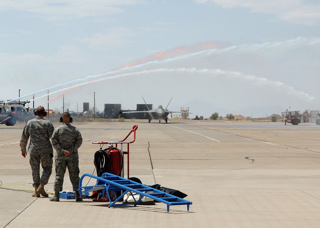 An F-22 Raptor taxis through red, white and blue water streams June 2 at Holloman Air Force Base, N.M., after landing at its new home. Holloman AFB is one of only four bases where the F-22s will be assigned. (U.S. Air Force photo/Airman 1st Class John Strong) 