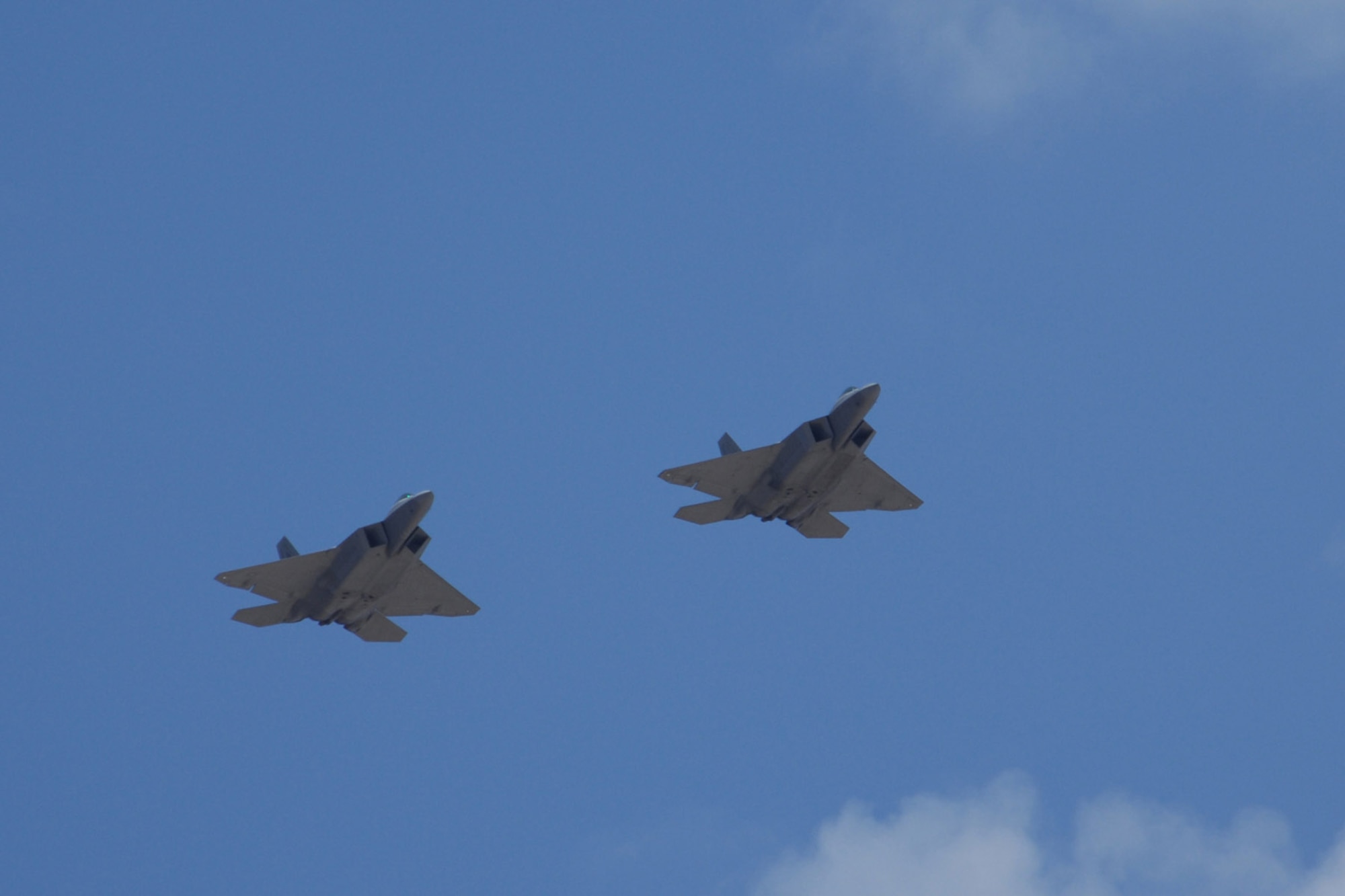 Col. Jeff Harrigian and Lt. Col. Mike Hernandez fly a pair of F-22A Raptors over Holloman Air Force Base, N.M., June 2. The jets are two of the newly assigned aircraft to arrive at Holloman AFB. Prior to landing, the jets flew over the Tularosa Basin, allowing the community members a chance to see the new aircraft. Colonel is the 49th Fighter Wing commander and Colonel Hernandez is the 7th Fighter Squadron commander. (U.S. Air Force photo/Airman 1st Class Jamal D. Sutter) 