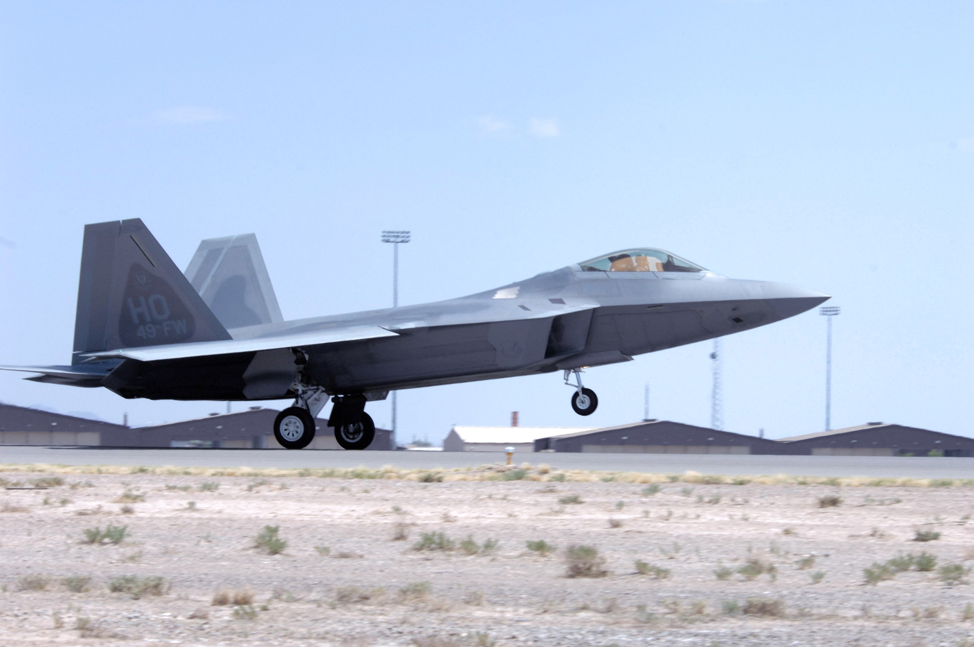 An F-22 Raptor flown by Col. Jeff Harrigian arrives June 2 at Holloman Air Force Base, N.M., June 2. Holloman AFB is one of four bases the F-22s will be assigned at. Prior to landing, the jets flew over the Tularosa Basin, giving community members a chance to see the new aircraft. (U.S. Air Force photo/Senior Airman Anthony Nelson) 