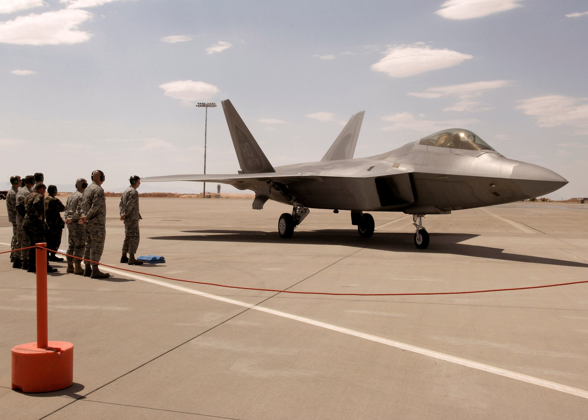 Flightline personnel wait to perform shutdown checks June 2 for an F-22 Raptor arriving at Holloman Air Force Base, N.M. The aircraft is one of the first F-22s now assigned to the base to arrive. (U.S. Air Force photo/Airman 1st Class Rachel A. Kocin)