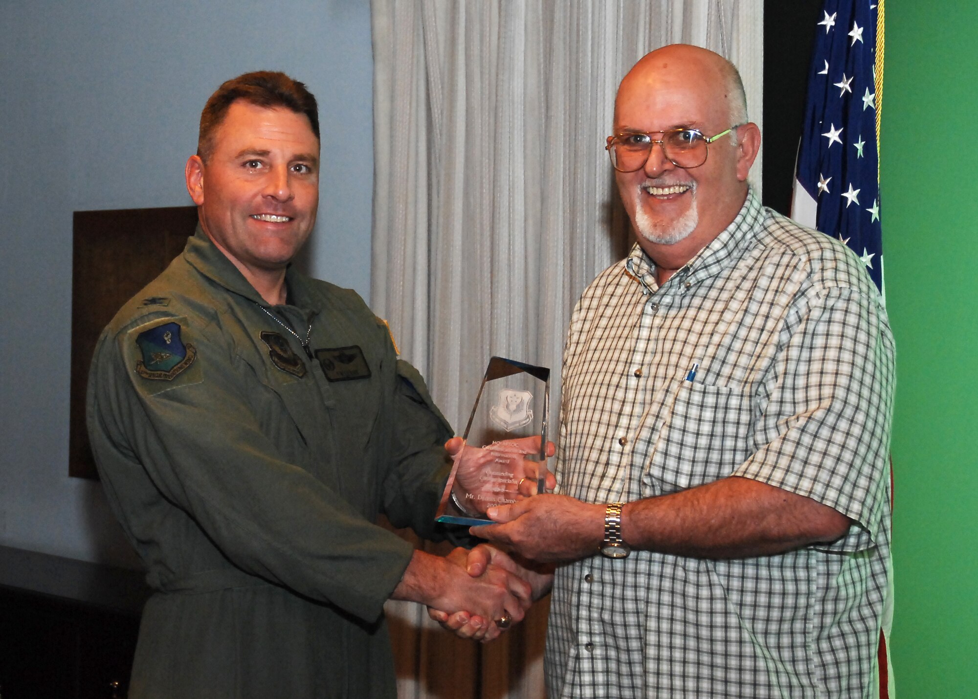 CANNON AIR FORCE BASE, N.M. --  Dennis Chambers, 27th Special Operations Communications Squadron, receives the Outstanding Civilian Specialist Award presented by Col. Timothy Leahy, 27th Special Operations Wing commander.  Mr. Chambers received the award at the weekly wing staff meeting on June 4.  (U.S. Air Force photo/Senior Airman Liliana Moreno)