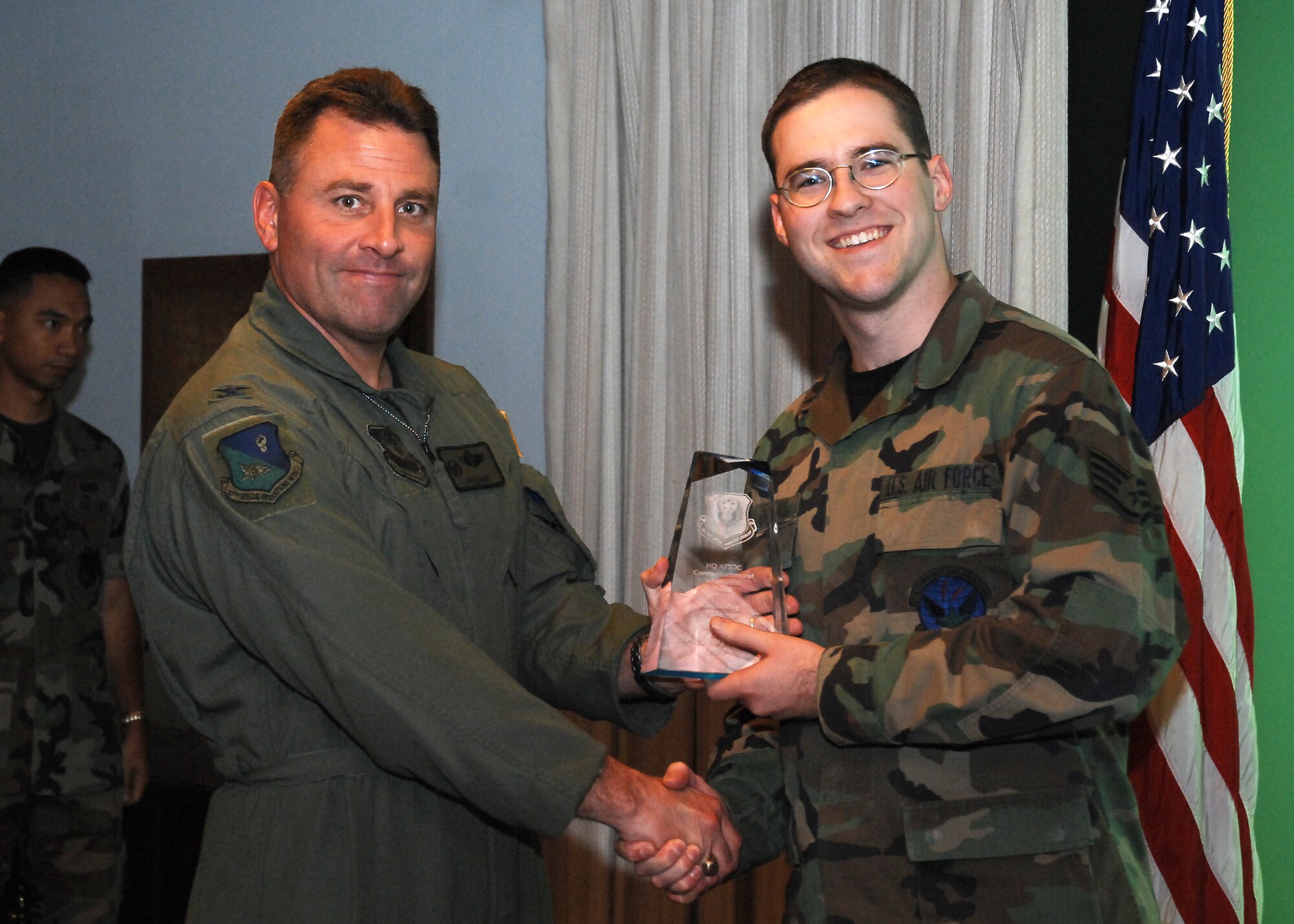 CANNON AIR FORCE BASE, N.M. --  Senior Airman Zachary Hawkins, 27th Special Operations Communications Squadron, receives the Communications-Computer System Outstanding Airman Award presented by Col. Timothy Leahy, 27th Special Operations Wing commander.  Airman Hawkins received the award at the weekly wing staff meeting on June 4.  (U.S. Air Force photo/Senior Airman Liliana Moreno)