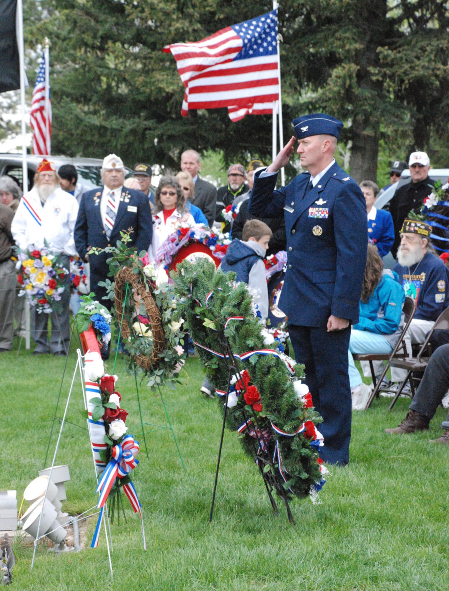 Col. Bryant Anderson, 90th Operations Group commander, salutes after laying a wreath (Photo by 2nd Lt. Lisa Meiman).