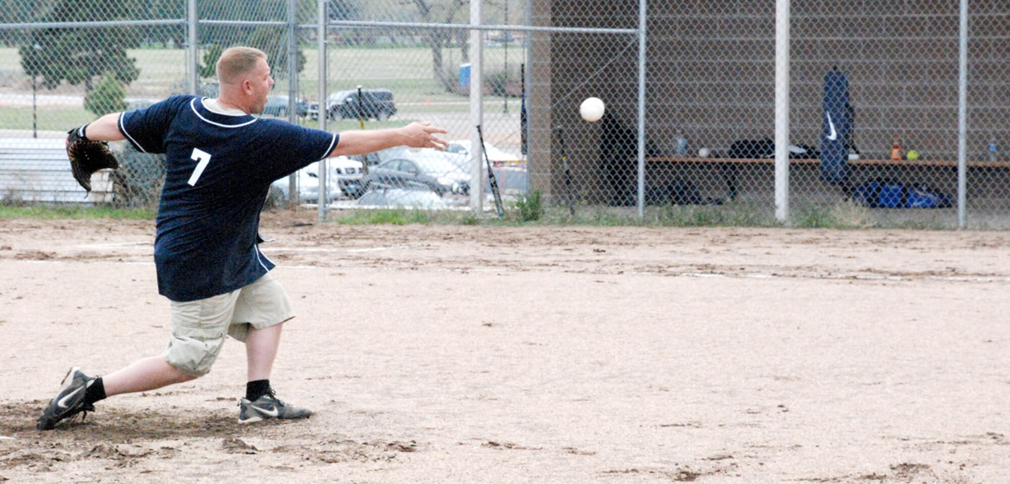 Tech. Sgt. Christopher Martin, 90th Maintenance Group team, hurls the softball toward the plate May 28 during the 90th MXG versus the 30th Airlift Squadron, 153rd Air Wing and 37th Helicopter Squadron combined team. The combined 30th AS, 153rd AW and 37th HS team forfeited for lack of participation (Photos by Airman 1st Class Daryl Knee).