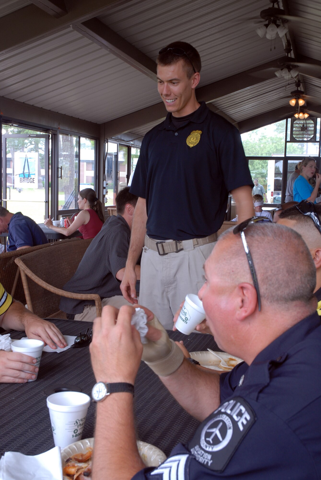 Special Agent "Greg" talks to officers from the Charleston County Aviation Authority at the annual Law Enforcement Liaison Luncheon May 30.The local Air Force Office of Special Investigations held the event to build relationships with local law enforcement agencies. (U.S. Air Force photo/Senior Airman Sam Hymas)
