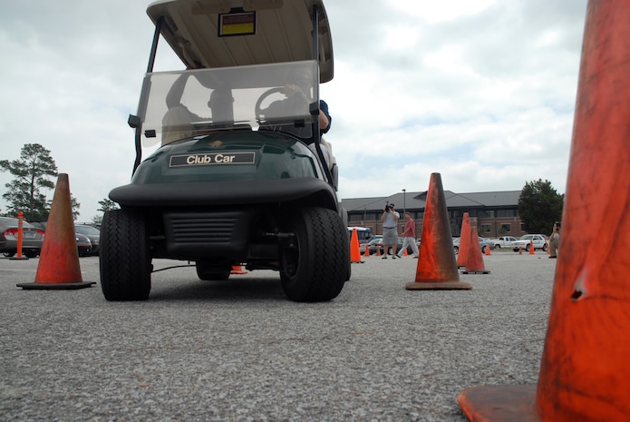 Special Agent "Shane" and Special Agent "Russ" navigate the drunk driving simulation course wearing goggles that impair vision in the Charleston Club parking lot May 30. The local Air Force Office of Special Investigations held their annual Law Enforcement Liaison Luncheon to build relationships with local law enforcement agencies. Participants had the opportunity to drive the course and fire at the small arms range. (U.S. Air Force photo/Senior Airman Sam Hymas)