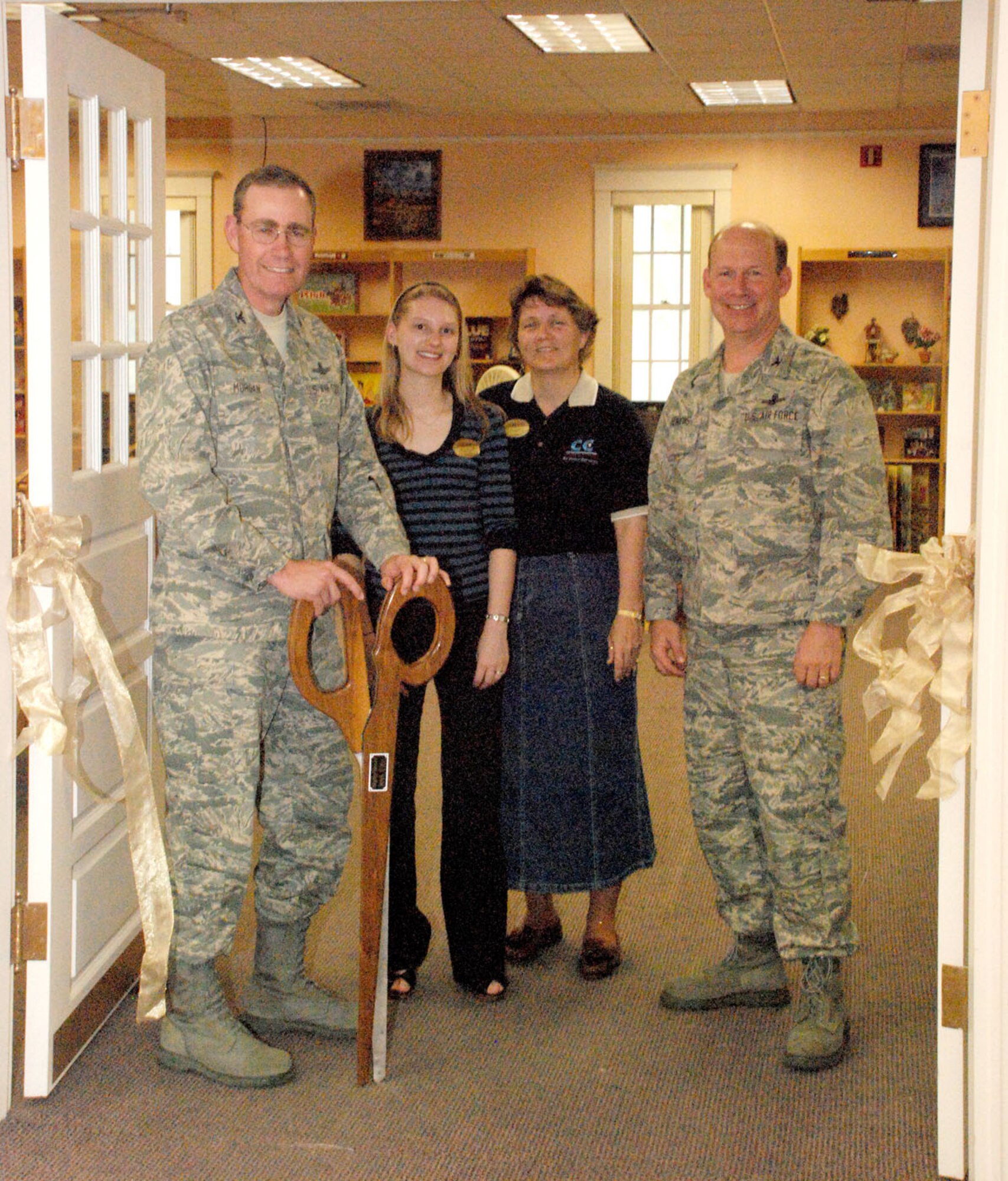 Col. Mike Morgan, 90th Space Wing commander, cuts the ribbon for the grand opening of the communibrary. Pictured with him are Nicole Bejcek, communibrary librarian; Tara Morton, community center director; and Col. Ron Jenkins, 90th Mission Support Group commander (Photos by Capt. Nora Eyle).