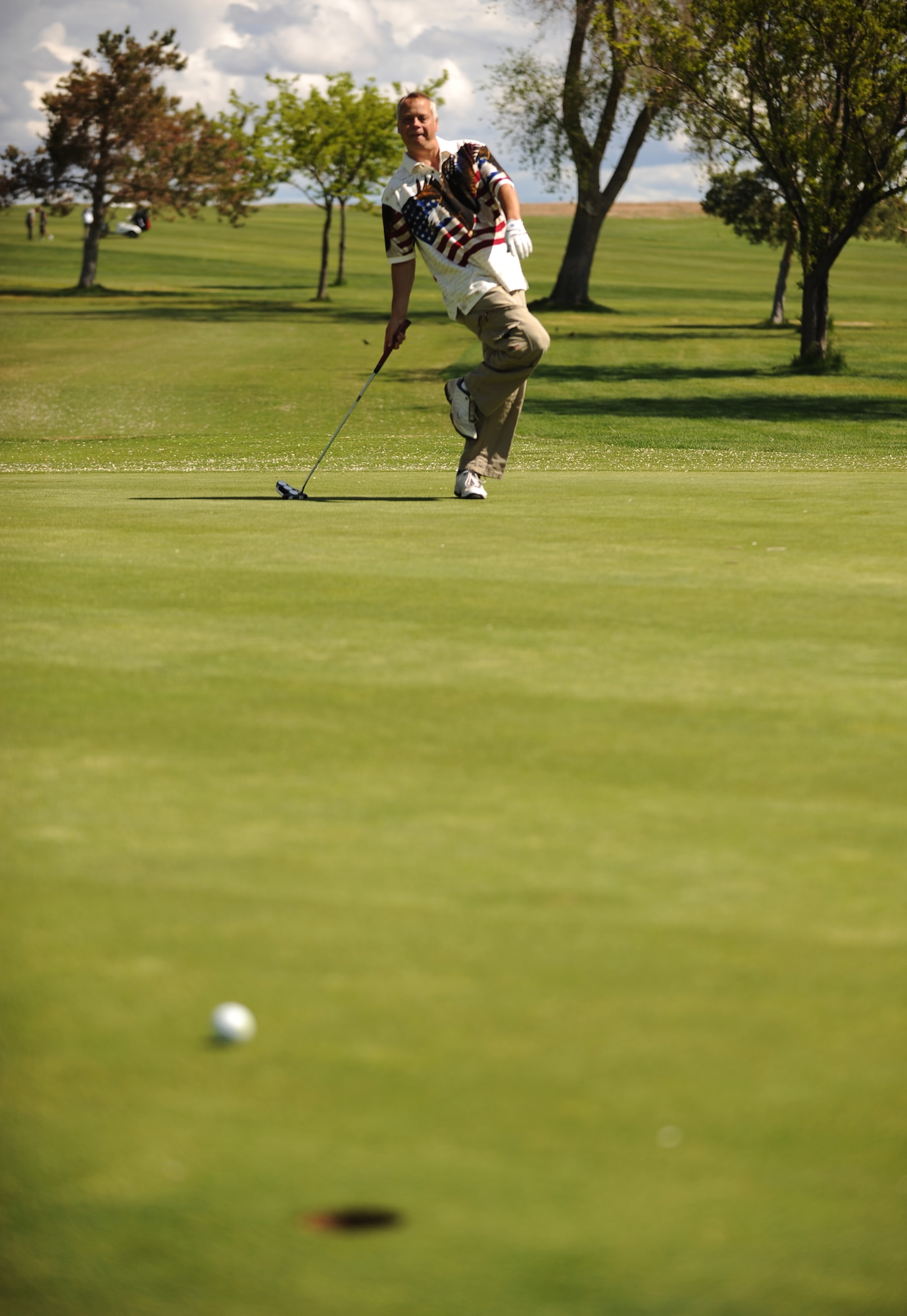 MOUNTAIN HOME AIR FORCE BASE, Idaho - Senior Master Sgt. Carl Brazier, 366th Aircraft Maintenance Squadron, tries to coax the ball into the hole on a 50-foot putt during the Operation Warmheart Golf Tournament at Silver Sage Golf Course May 30. Operation Warmheart is a program run by the Mountain Home Air Force Base first sergeants to raise money in support of local Gunfighter families and other members of the local communities. Operation Warmheart also holds a softball tournament, a holiday food drive and numerous other fund raisers to support this community. (U.S. Air Force photo/ Airman 1st Class Ryan Crane)