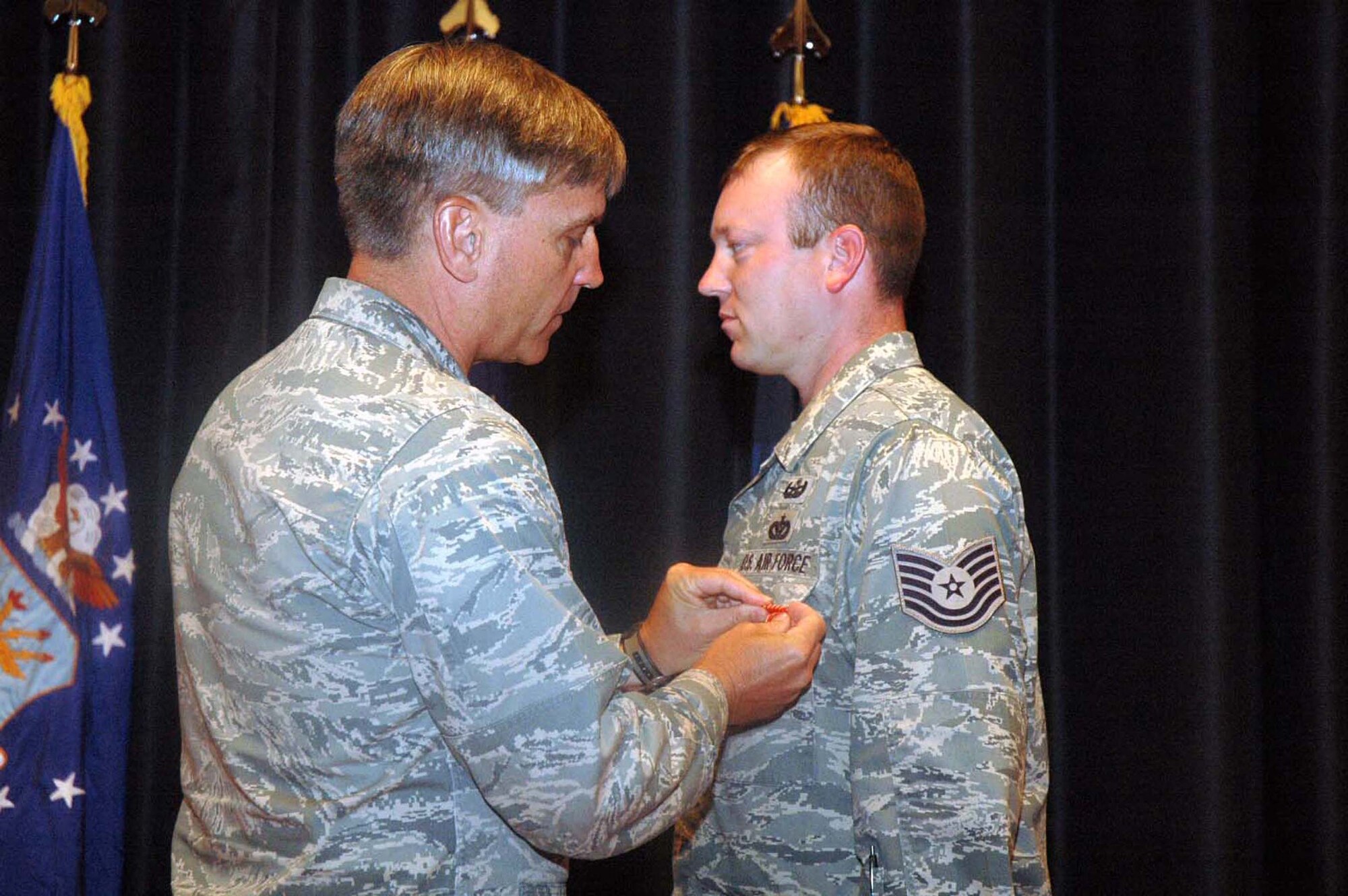 Maj. Gen. Kip Self, U.S. Air Force Expeditionary Center commander, pins the Air Force Combat Action Medal on Tech. Sgt. Vandiver Hood of the Center's 421st Combat Training Squadron June 3, 2008, in the Center's Grace Peterson Hall at Fort Dix, N.J.  This was Sergeant Hood's second AFCAM he earned for valor while deployed as part of an explosive ordnance disposal weapons intelligence team in Iraq.  He returned from that deployment in February.  (U.S. Air Force Photo/Tech. Sgt. Scott T. Sturkol)