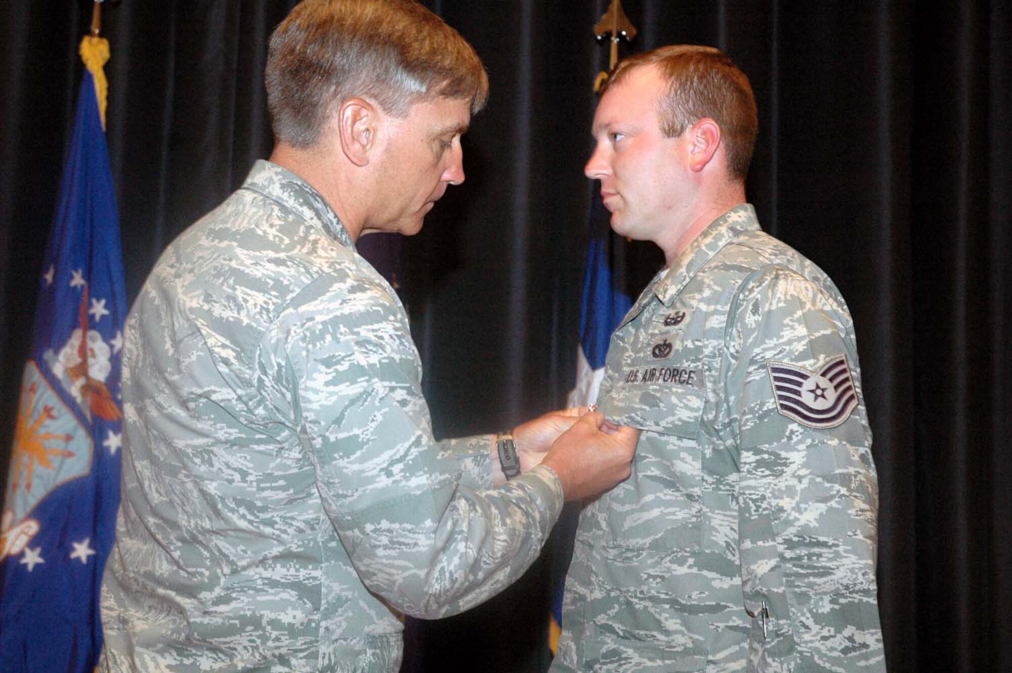 Maj. Gen. Kip Self, U.S. Air Force Expeditionary Center commander, pins on the Bronze Star on Tech. Sgt. Vandiver Hood of the Center's 421st Combat Training Squadron June 3, 2008, in the Center's Grace Peterson Hall at Fort Dix, N.J.  This was Sergeant Hood's second Bronze Star he earned for valor while deployed as part of an explosive ordnance disposal weapons intelligence team in Iraq.  He returned from that deployment in February.  (U.S. Air Force Photo/Tech. Sgt. Scott T. Sturkol)