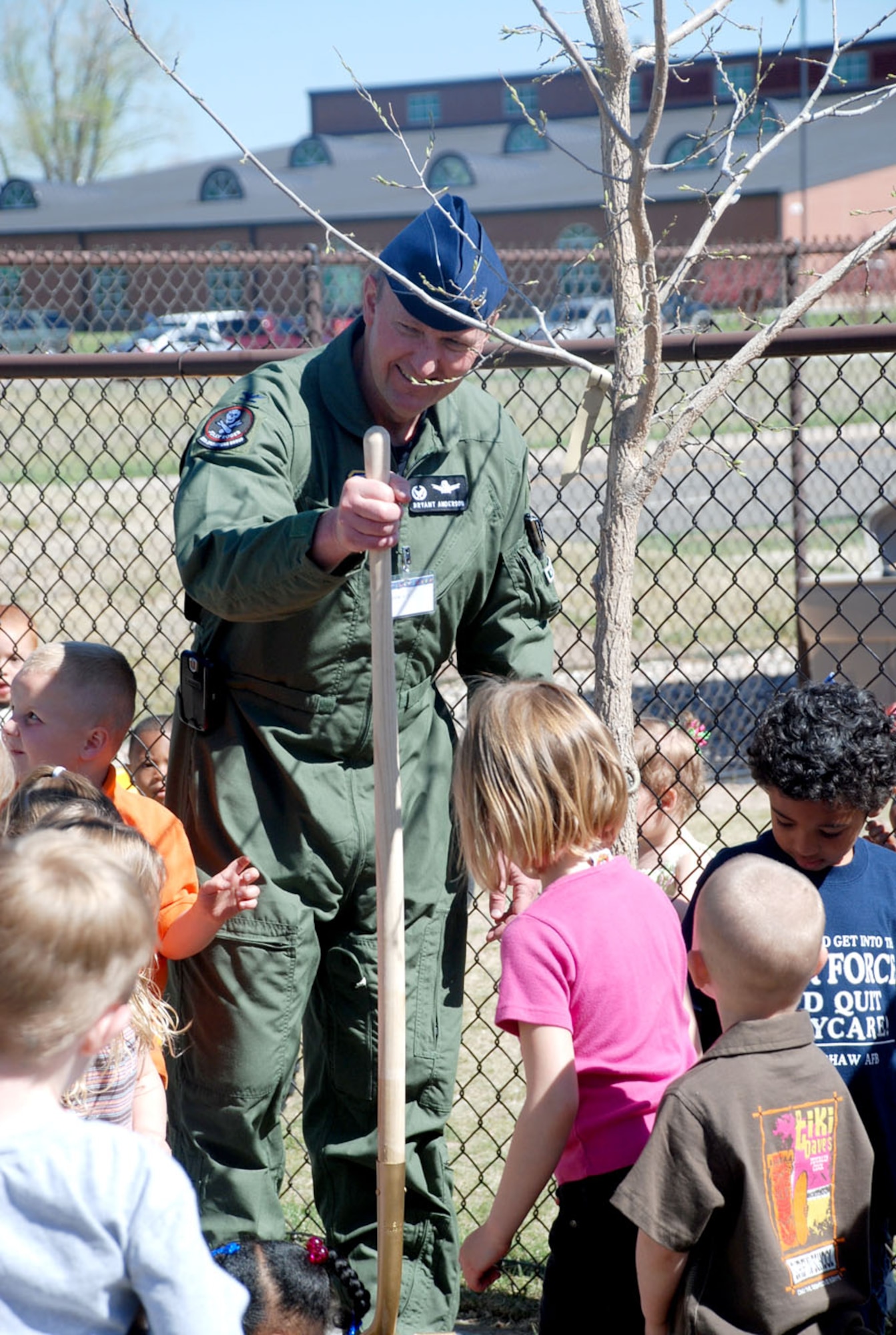 Col. Bryant Anderson, 90th Operations Group commander, speaks May 20 with the children at Warren's Child Development Center as he finishes dedicating a hackberry tree for Arbor Day.