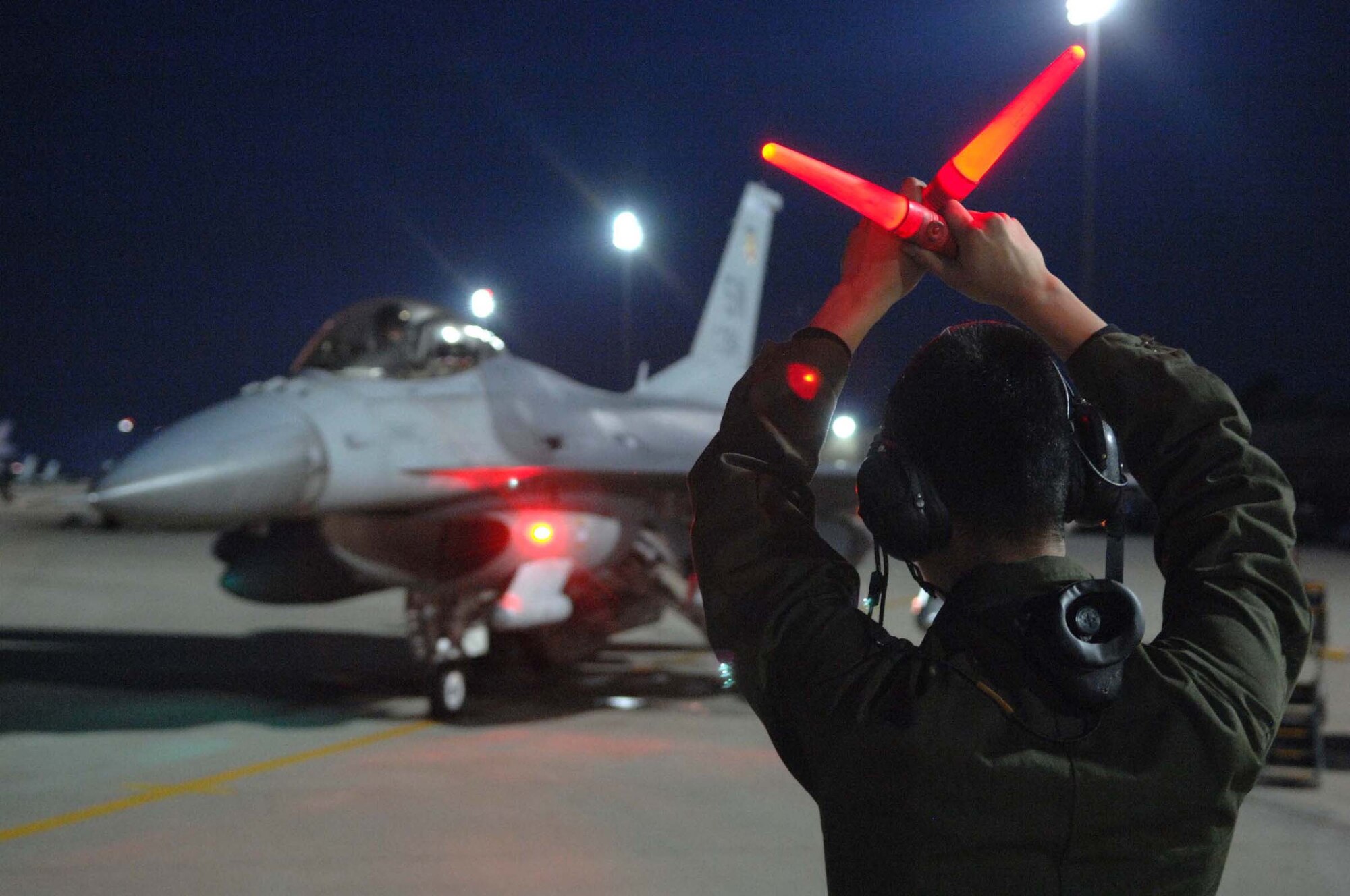 SHAW AIR FORCE BASE, S.C. -- Airman 1st Class Shuan Lim, 79th Fighter Squadron crew chief, marshalls Capt. Greg Boland, 79th FS F-16 pilot, prior to take off for deployment support for the 77th FS. More than 200 Airmen and a dozen F-16s from the 20th Fighter Wing deployed to  Iraq to support the Global War on Terrorism. (U.S. Air Force photo/Airman 1st Class Matthew Davis)