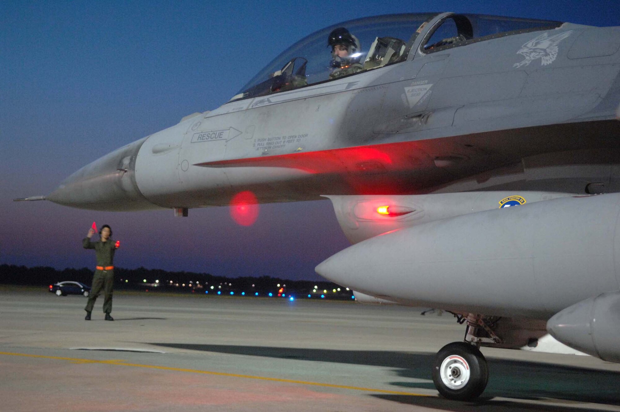 SHAW AIR FORCE BASE, S.C. -- Airman 1st Class Shuan Lim, 79th Fighter Squadron crew chief, marshalls Capt. Greg Boland, 79th FS F-16 pilot, prior to take off for deployment support of the 77th FS to Balad Air Base, Iraq. More than 200 Airmen and a dozen F-16s from the 20th Fighter Wing deployed to Iraq to support the Global War on Terrorism. (U.S. Air Force photo/Airman 1st Class Matthew Davis)