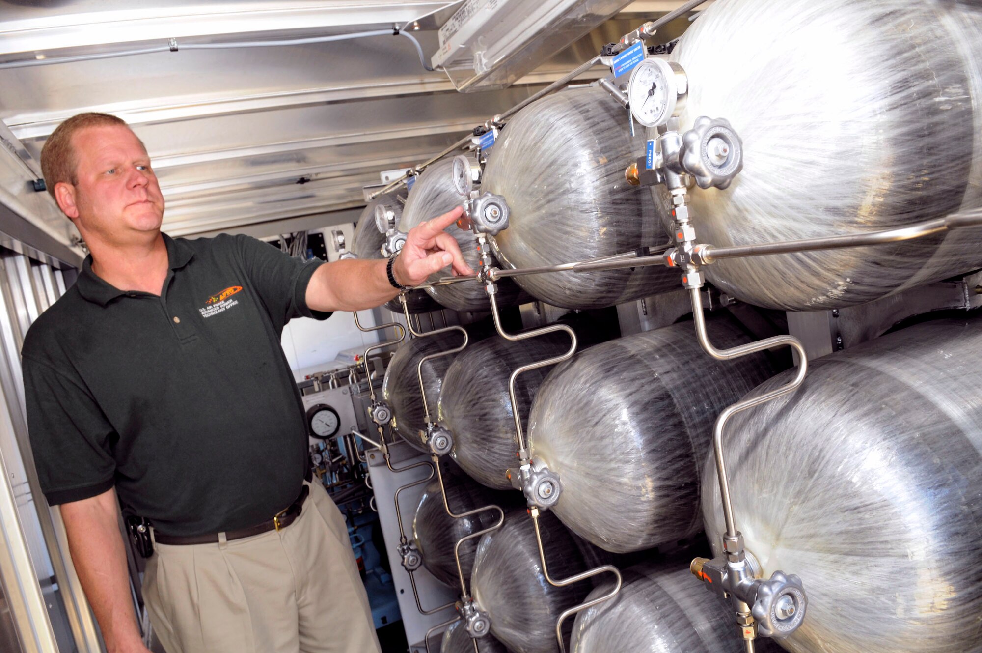 Scott Slyfield examines hydrogen storage tanks inside the HyHauler May 21 at Robins Air Force Base, Ga. Air Force officials continue initiatives to redefine the Air Force's energy culture and are studying hydrogen-power. Mr. Slyfield is a Advanced Power Technology Office program manager. (U.S. Air Force photo/Sue Sapp) 
