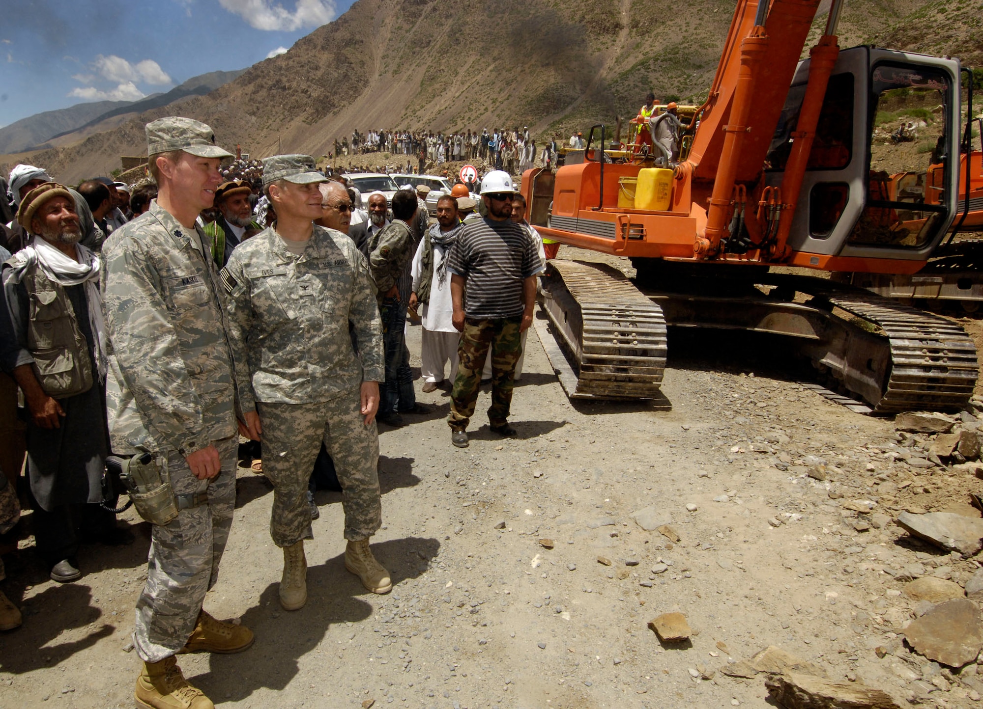 PANJSHIR PROVINCE, Afghanistan -- Army Col. Jonathan G. Ives, Task Force Cincinnatus commander, right, and Lt. Col. Russell T. Kaskel, Panjshir Provincial Construction Team commander, lead a group of more than 1,000 Panjshiris to the edge of the paved road May 28 in Barak, Bazarak District, Panjshir, where the new $6 million Barak to Khenj road will start construction.  The 18 kilometer two-lane road is expected to be complete in March 2009. (U.S. Air Force photo by Master Sgt. Demetrius Lester)