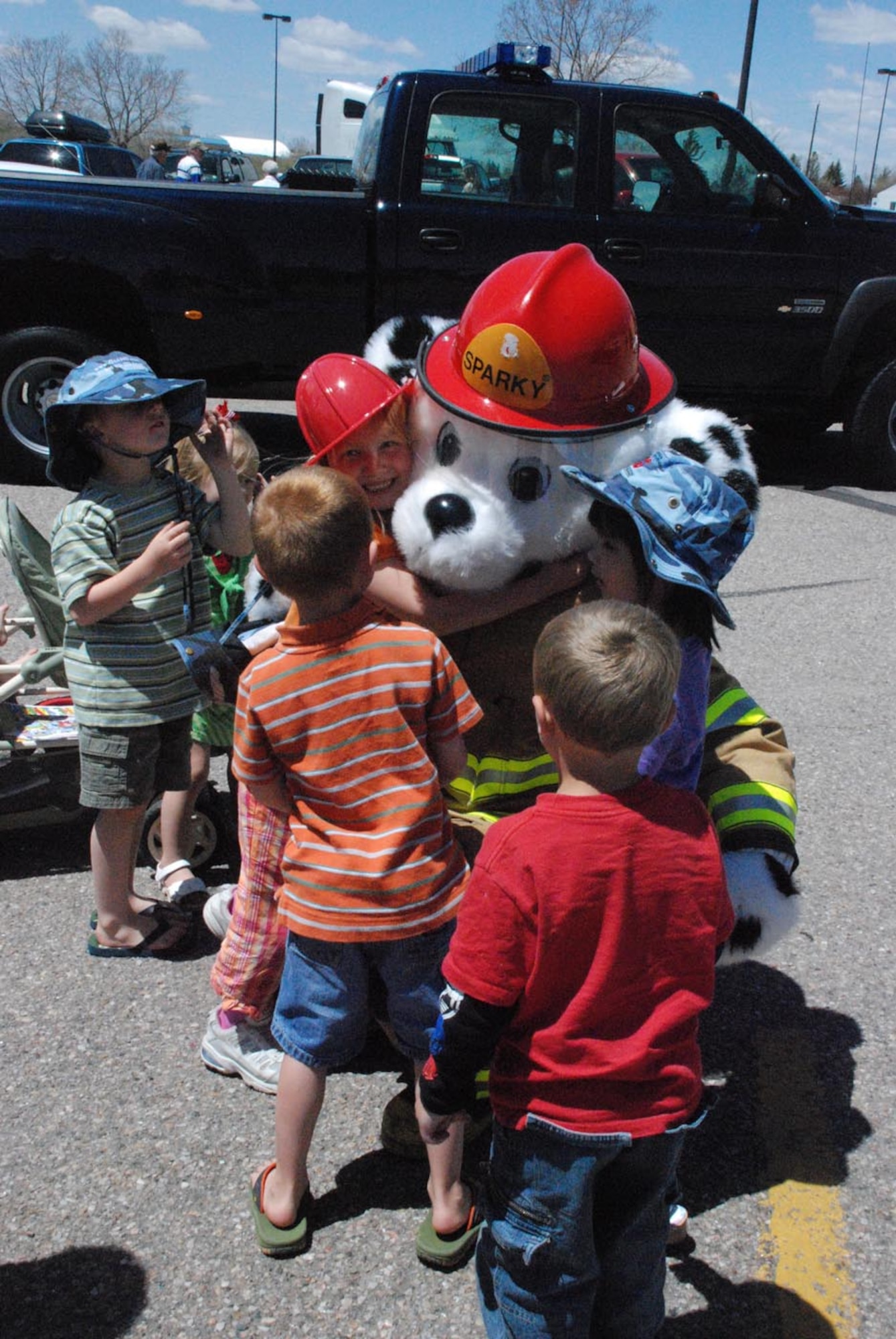 Sparky the firedog receives hugs from local children as he walks around Frontier Mall May 17. Sparky and McGruff the Crime Dog teamed up on Armed Forces Day to educate children on the dangers of fire, drugs and crime.