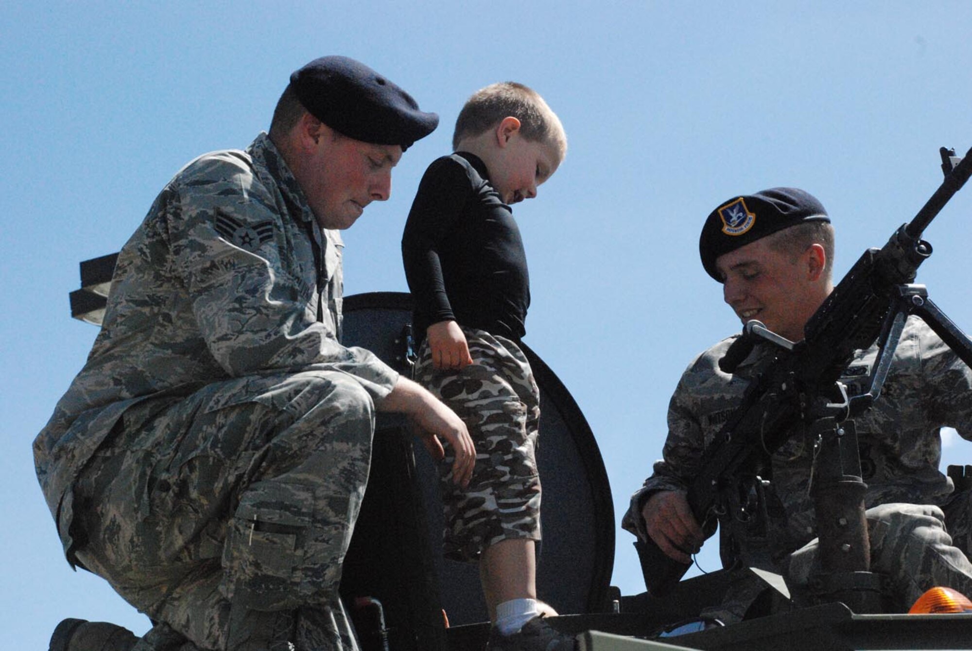 Luke Hobbs, a local resident, examines a Bearcat gun turret as Senior Airman Daniel Voliva, 790th Missile Security Forces Squadron, and Airman 1st Class Joseph Whitson, 790th MSFS, explain how it works in the Frontier Mall parking lot during Armed Forces Day May 17. Nearly 300 Airmen participated in Armed Forces Day to demonstrate their capabilities and equipment to Cheyenne residents (Photos by 2nd Lt. Lisa Meiman).