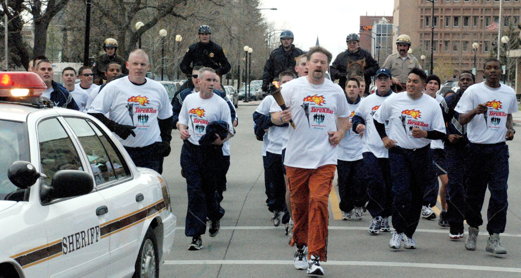 Members of Warren and the local police department run a torch toward the capitol building May 16. Many police departments worked together to bring the Special Olympic torch to various parts of Wyoming before coming to its final stop in Laramie, Wyo. Warren's security forces traveled from Wheatland, Wyo., for a 72-mile trek to Warren. The next day, the cops ran to the capitol to hand it off to the Cheyenne Police Department.
