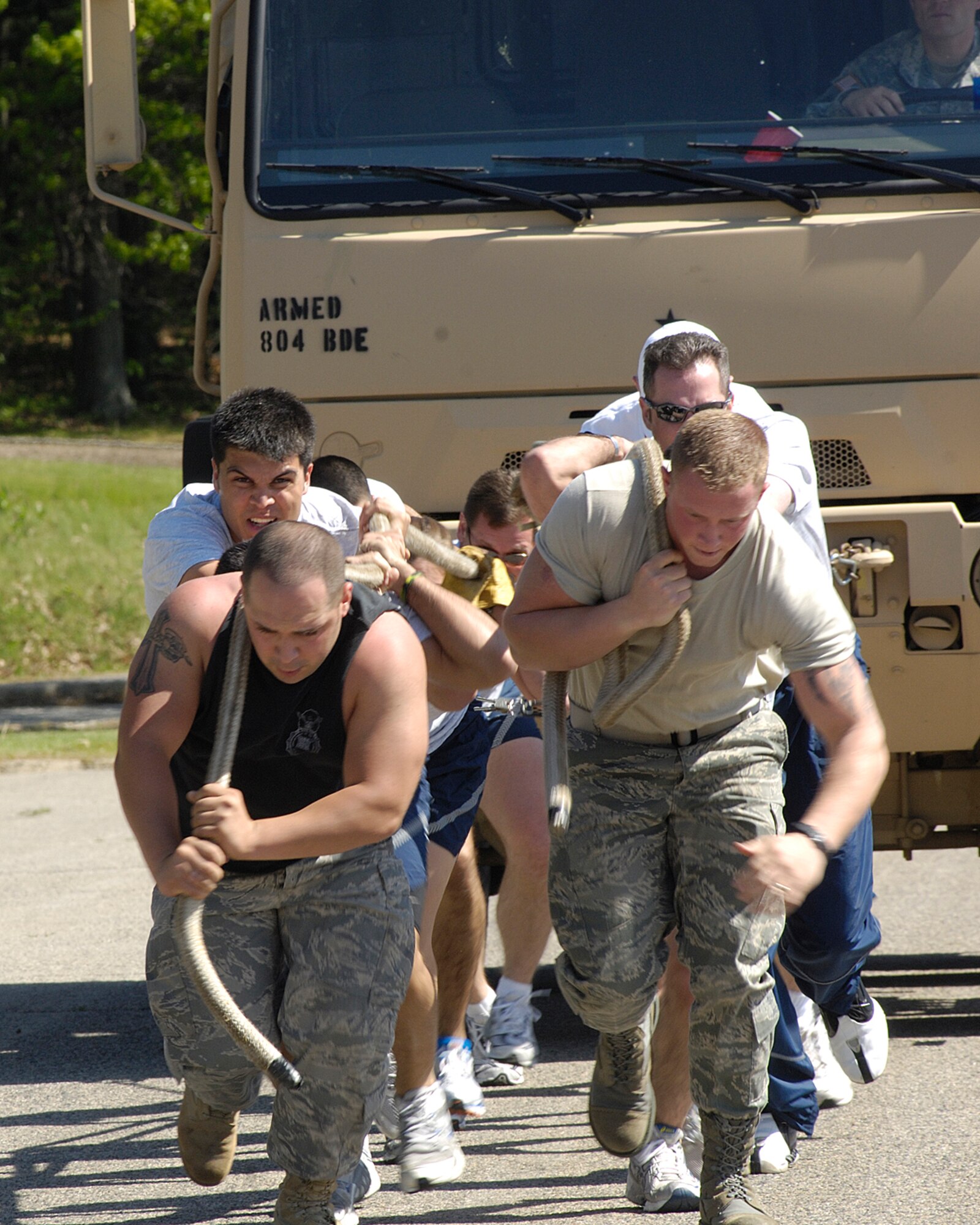 HANSCOM AFB, Mass. – The 66th Air Base Wing truck pull team moves a five-ton M939 truck on May 29 during the AFRL sponsored Monster Truck Pull competition. Five teams participated in the event with each team vying for the fastest time. The 551st Electronic Systems Wing unseated the reigning AFRL champions to earn the trophy and first place bragging rights with the fastest combined time of 30.92 seconds. (U.S. Air Force photo by Linda LaBonte Britt)