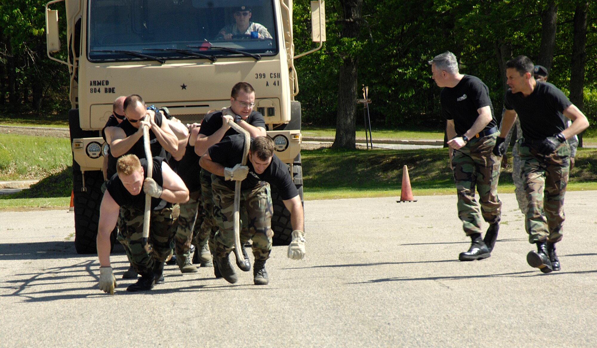 HANSCOM AFB, Mass. – Members of the Air Force Research Laboratory team try to get some momentum going to move a five-ton M939 truck on May 29 during the AFRL sponsored Monster Truck Pull competition. Five teams participated in the event with each team vying for the fastest time. The 551st Electronic Systems Wing unseated the reigning AFRL champions to earn the trophy and first place bragging rights with the fastest average time of 30.92 seconds. (U.S. Air Force photo by Linda LaBonte Britt)