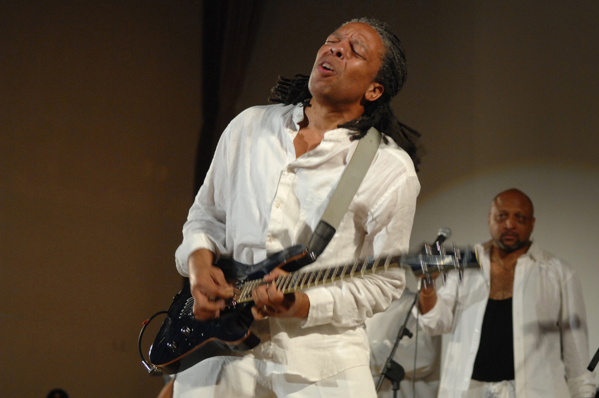 BALAD AIR BASE/LOGISTICS SUPPORT AREA ANACONDA, Iraq -- The lead guitarist for Con Funk Shun performs for personnel here, June 1. The Legends of Funk, a 14-member group consisting of three separate bands, the Barkays, Con Funk Shun and the Dazz Band toured several Air Force and Army assets here May 31 and June 1 to gain a better understanding of the military mission and lifestyle in a combat zone, before their concert June 1. (U.S. Air Force photo/ Senior Airman Julianne Showalter)