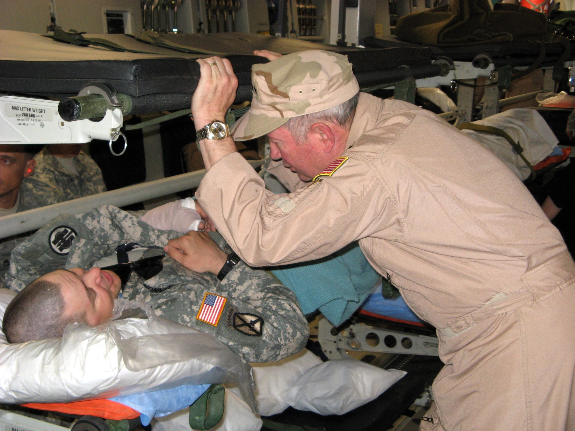 Gen. Duncan J. McNabb speaks to an injured Soldier May 29 during a flight from Iraq to Ramstein Air Base, Germany. General McNabb traveled to the Air Force Theater Hospital at Balad AB, Iraq, to visit wounded warriors and accompany them on a flight back to Ramstein AB. General McNabb is the Air Force vice chief of staff. (U.S. Air Force photo) 
